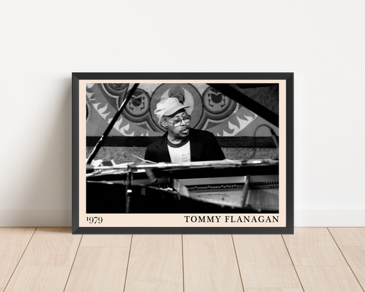 Tommy Flanagan framed art print mockup on wooden floor, featuring black and white 1979 piano portrait with modern decor.