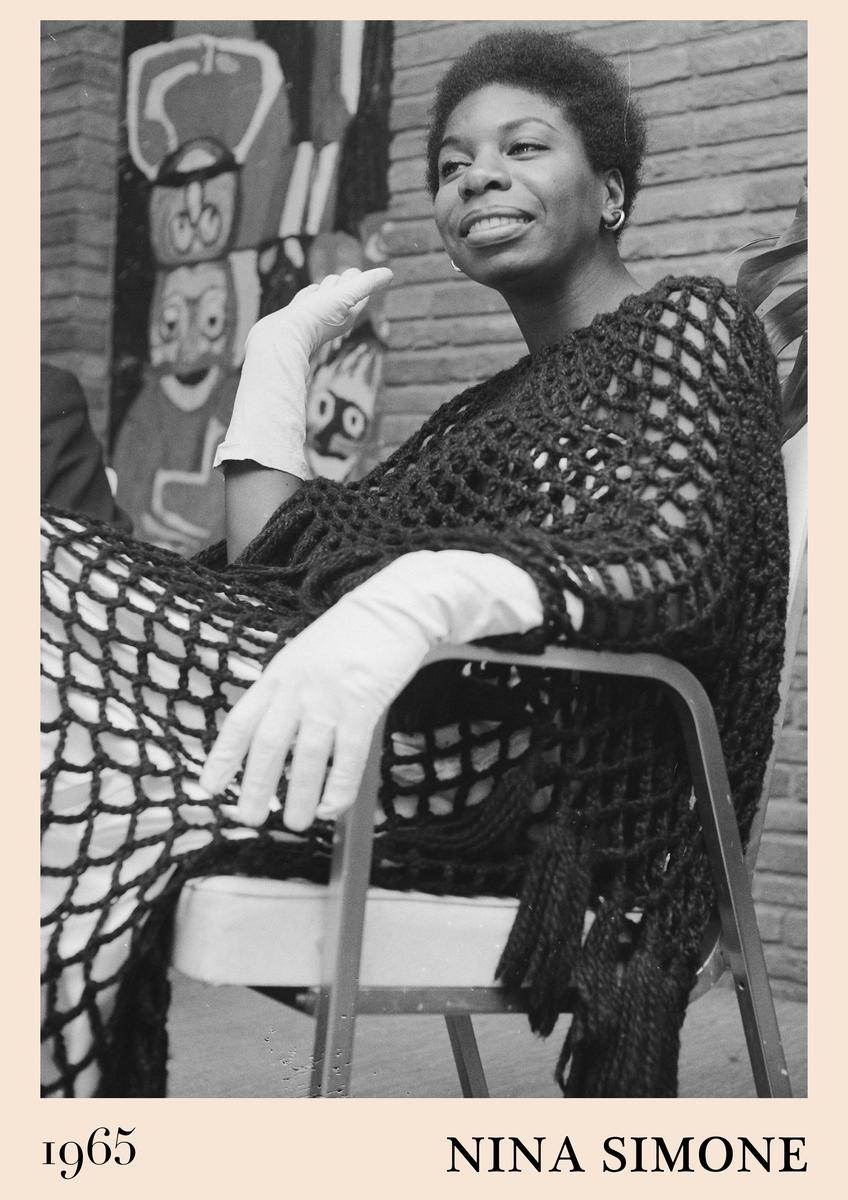 Poster features Nina Simone in 1965, seated in black open-knit shawl, white gloves, smiling, with abstract mural art on