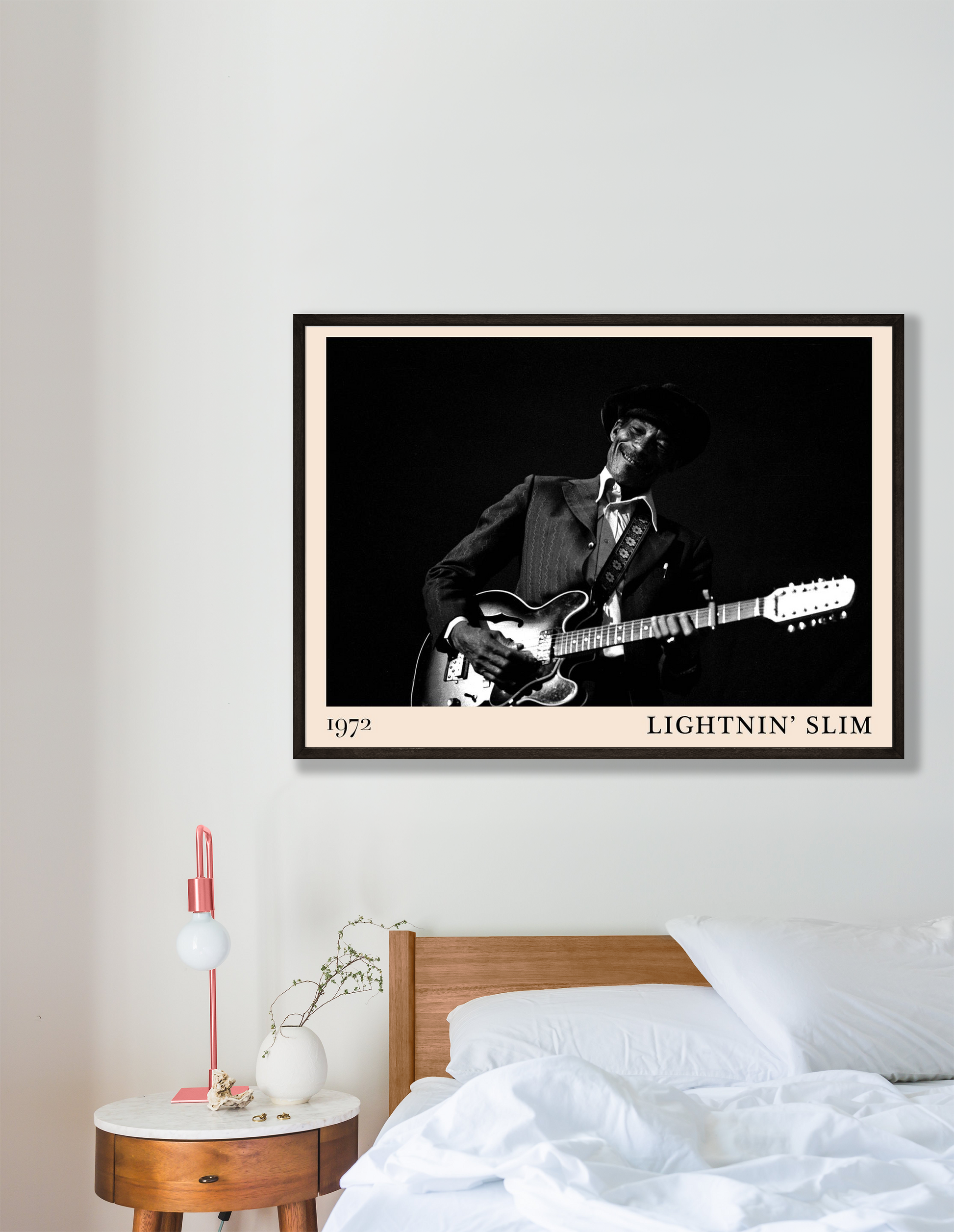 Lightnin Slim Blues Poster in landscape mockup above a modern bed, features black and white guitar portrait with 1972 date.