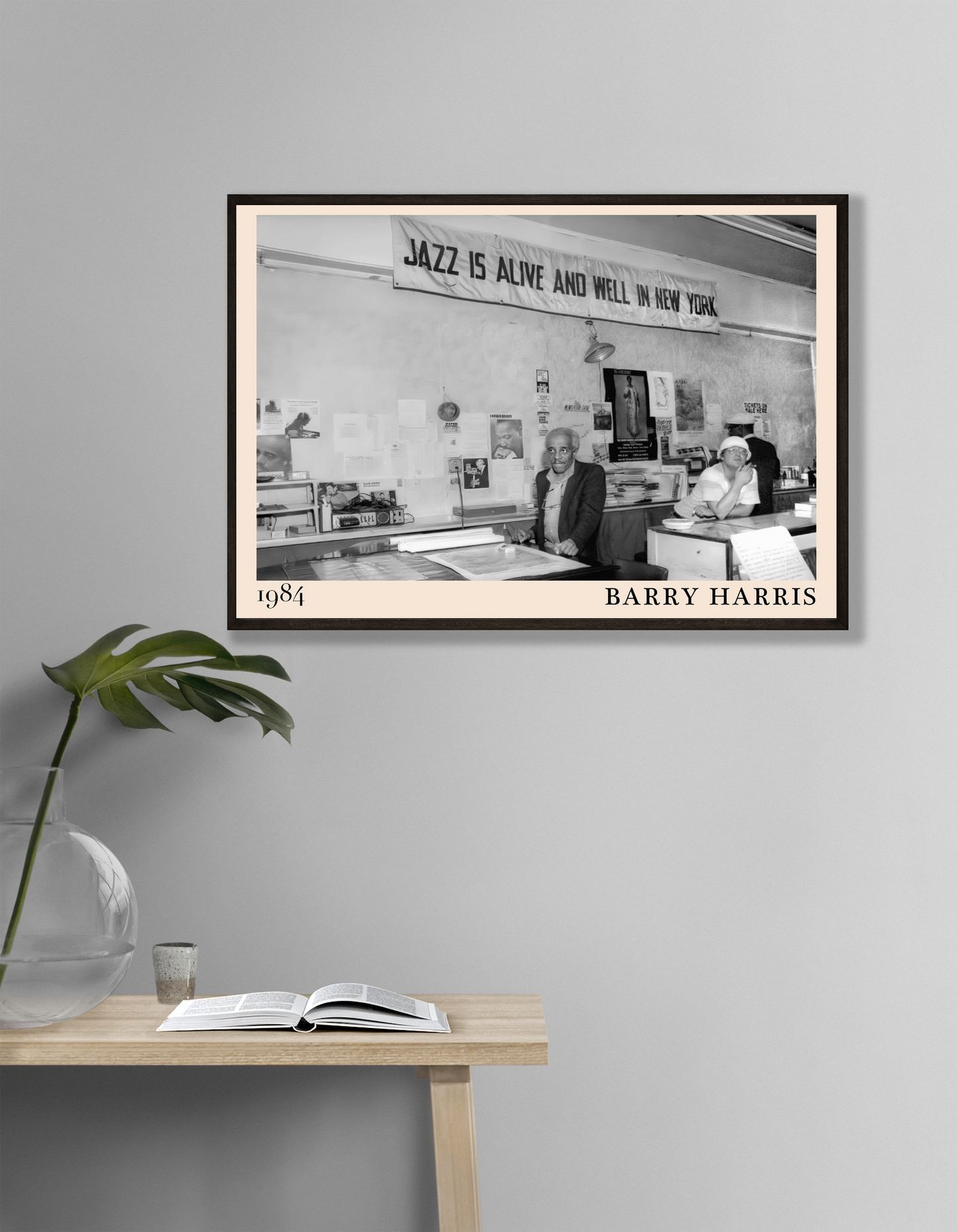 Barry Harris Retro Jazz Poster in landscape mockup, black and white 1984 jazz scene on wall above modern wooden table.