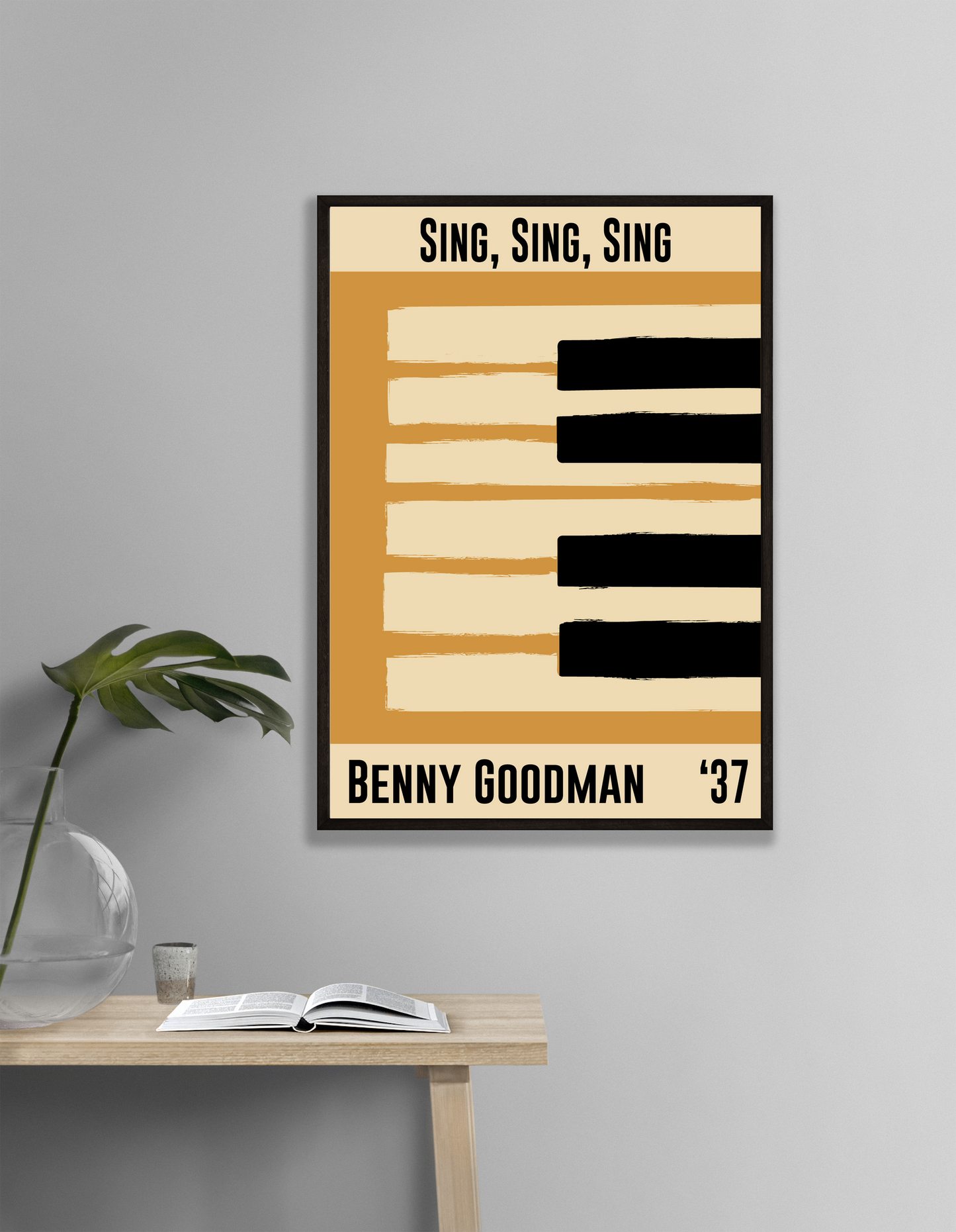 Framed poster with 'Sing, Sing, Sing' by Benny Goodman '37 on a wall above a table.