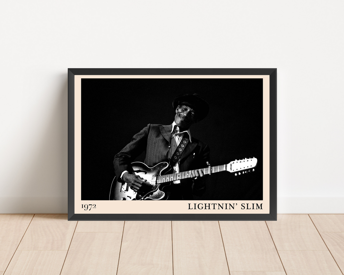 Lightnin Slim Blues Poster in landscape mockup, framed on wood floor, features black and white guitarist portrait, 1972 text.