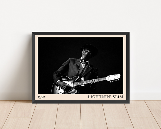 Lightnin Slim Blues Poster in landscape mockup, framed on wood floor, features black and white guitarist portrait, 1972 text.
