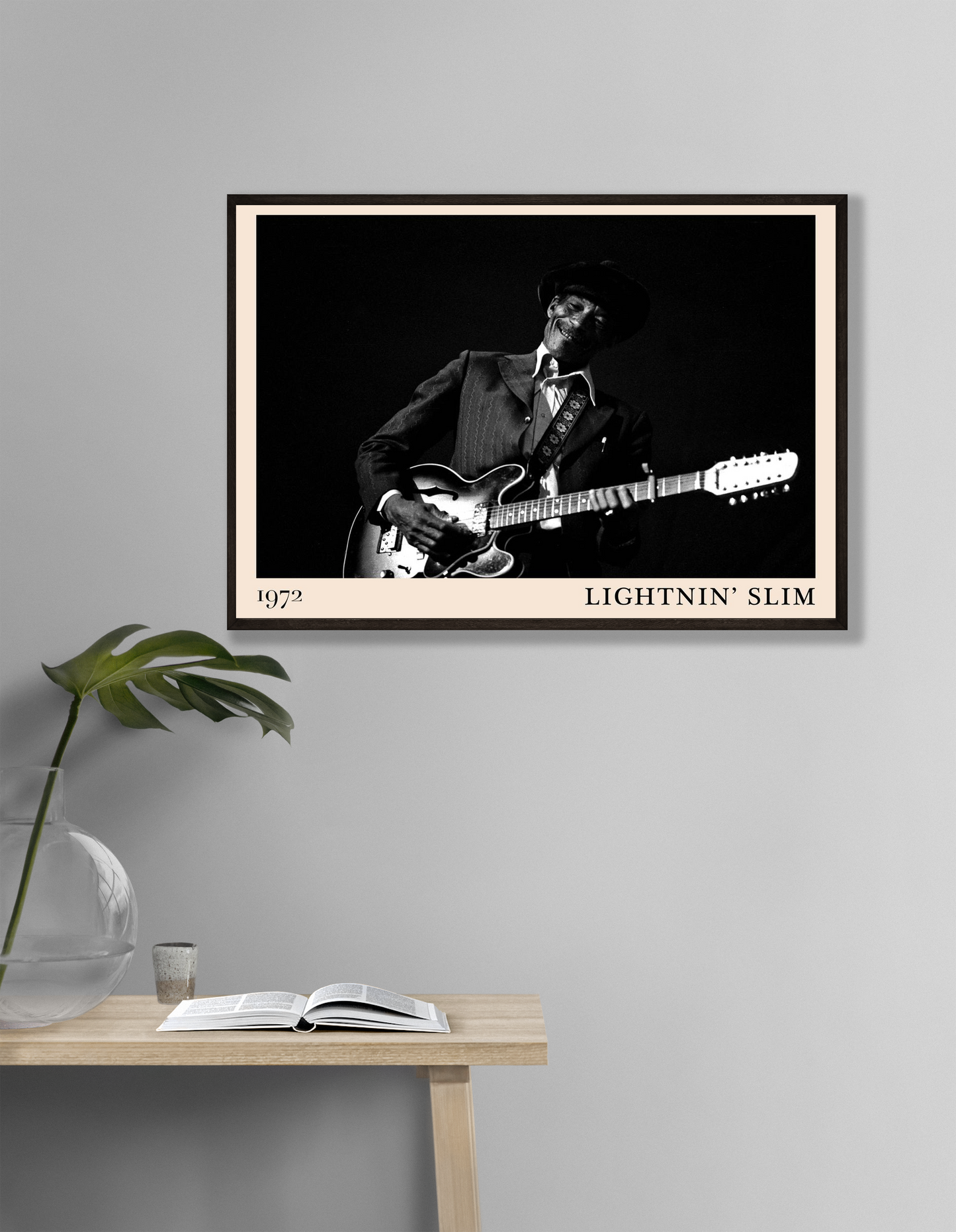 Lightnin Slim Blues Poster in landscape mockup, black and white guitar portrait on wall above minimalist wooden table.