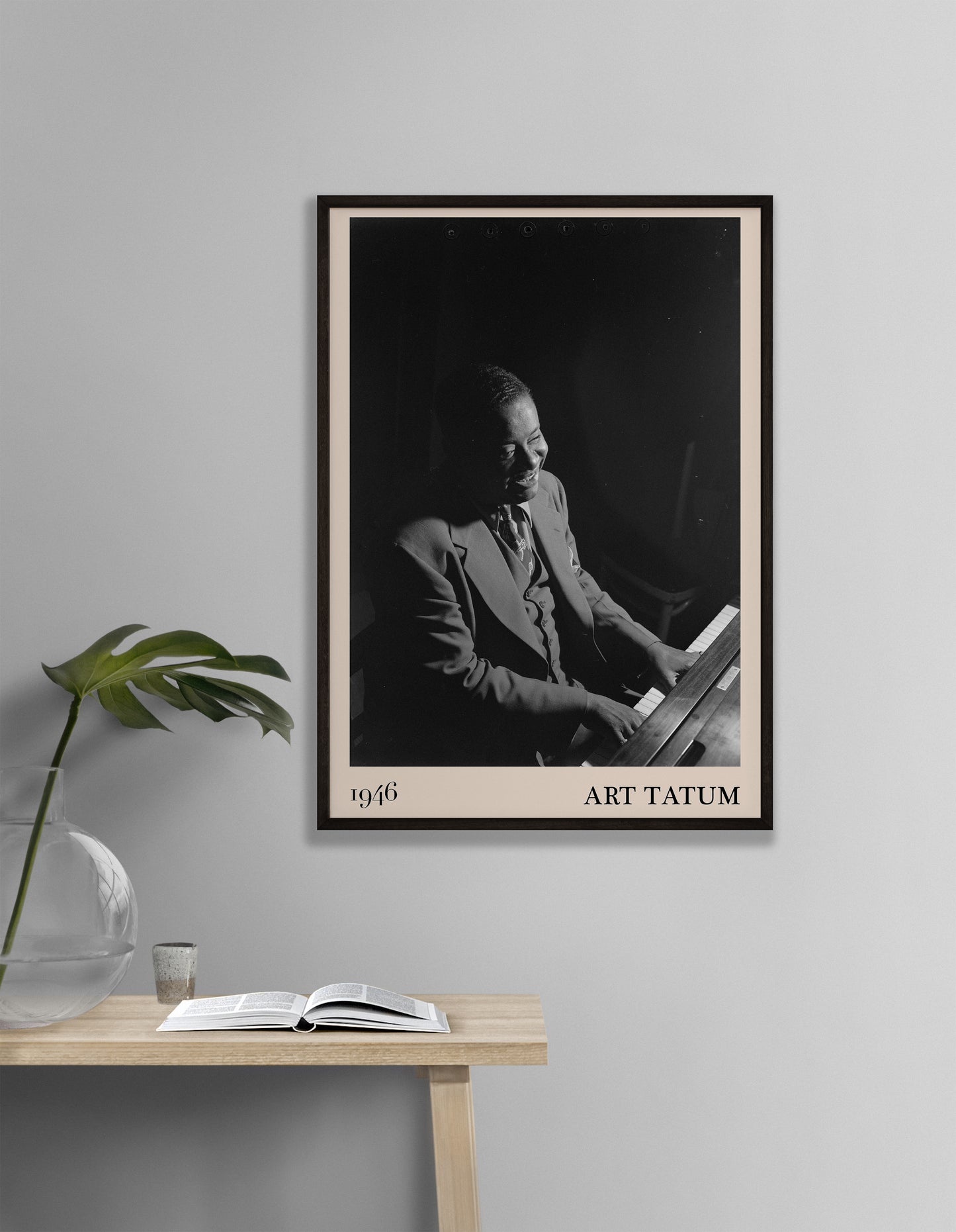 1946 photograph of Art Tatum crafted into a framed jazz poster. The poster has an off-white border and a thin black frame. The poster is hanging on a off-white wall.