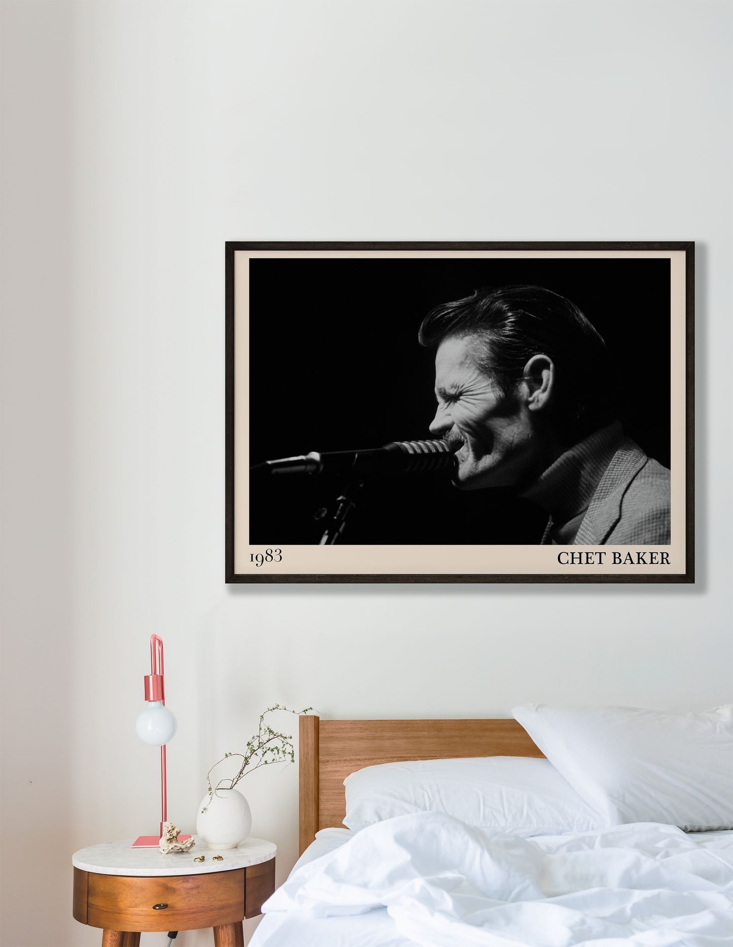 1983 photograph of Chet Baker singing, transformed into a stylish black-framed jazz poster hanging on a white bedroom wall