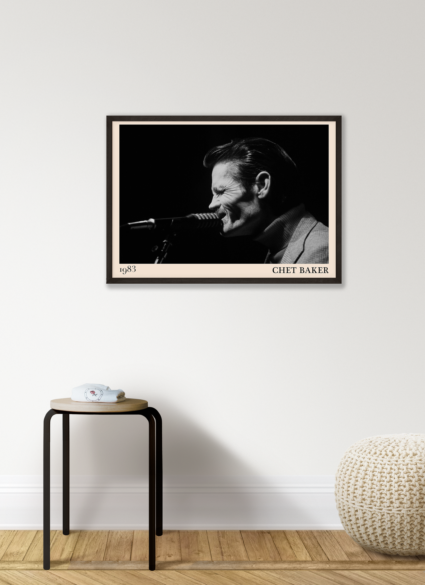 1983 photograph of Chet Baker singing, transformed into a stylish black-framed jazz poster hanging on a white living room wall