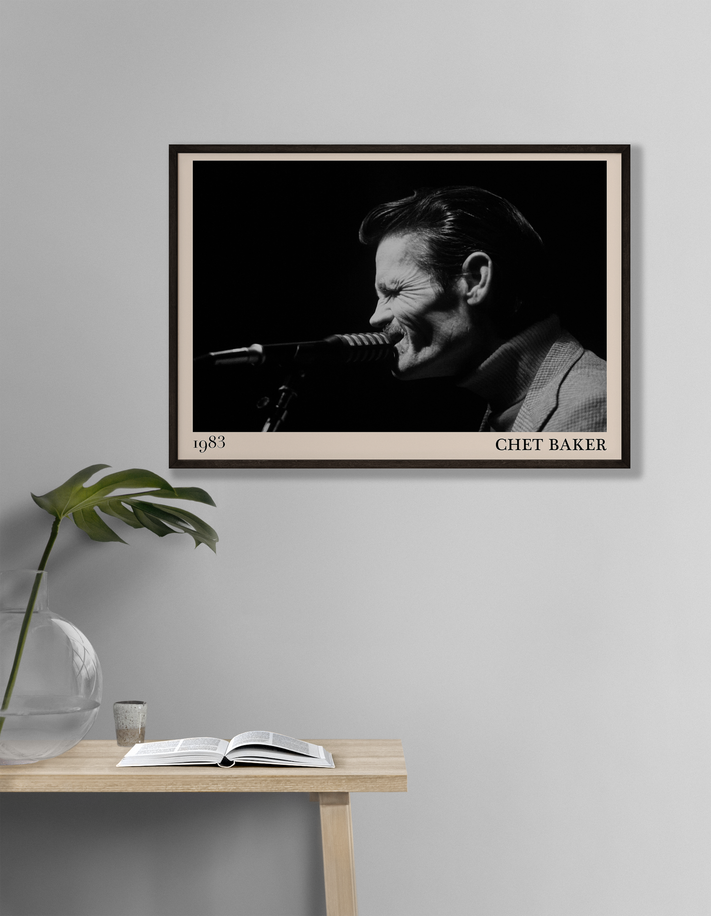 1983 photograph of Chet Baker singing, transformed into a stylish black-framed jazz poster hanging on a white living room wall
