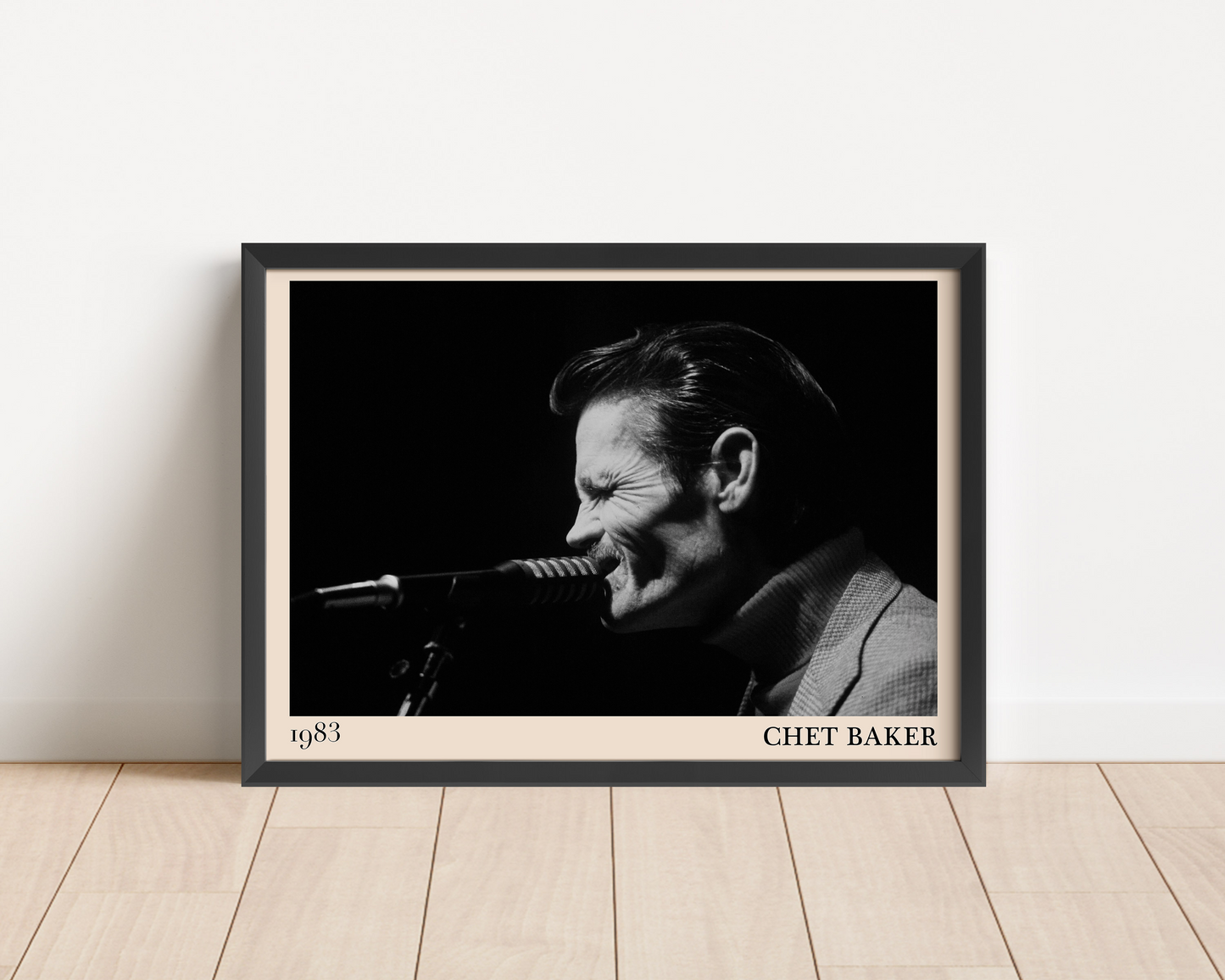 1983 photograph of Chet Baker singing, transformed into a stylish black-framed jazz poster leaning on a white wall