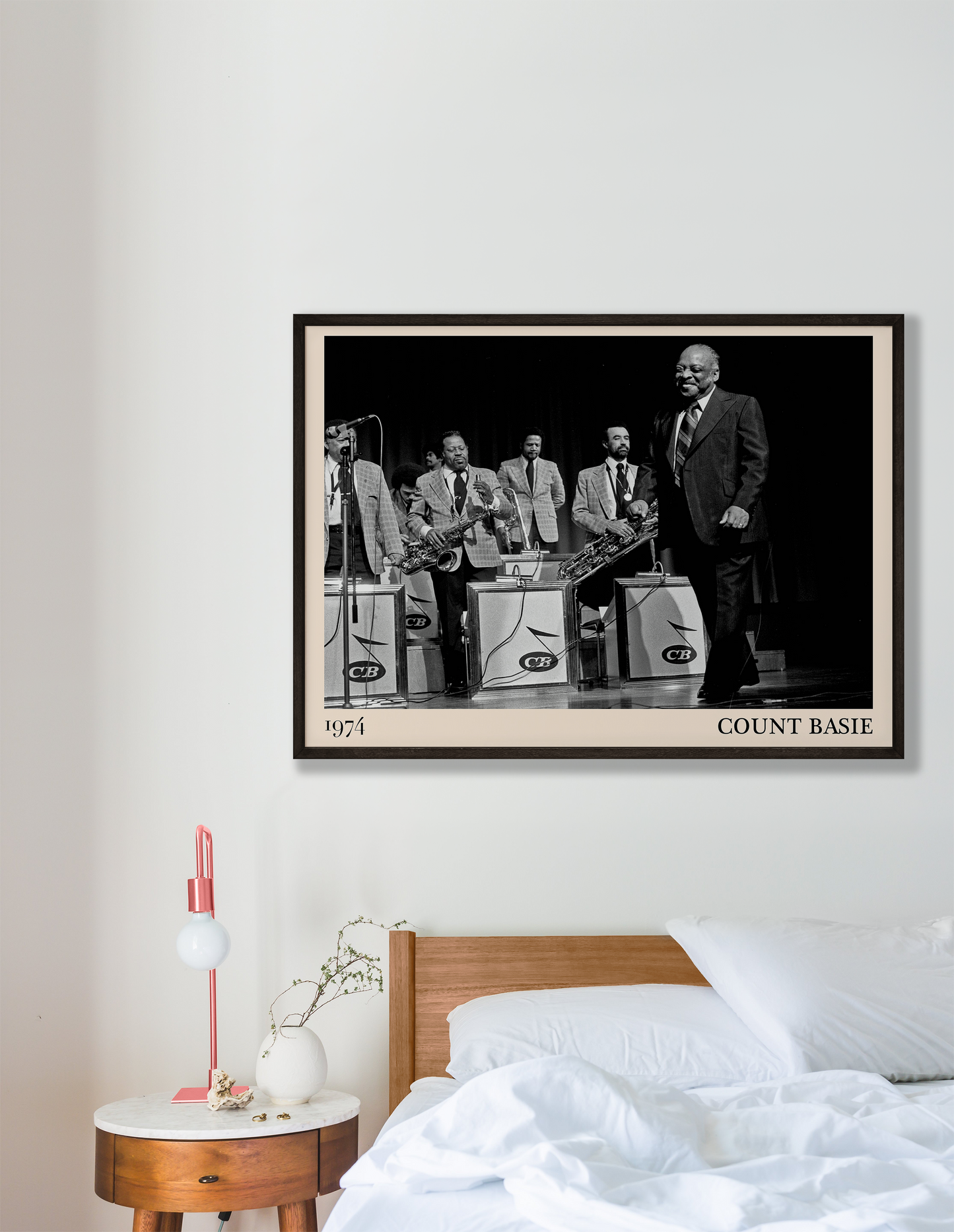 1974 photo of Count Basie crafted into a black framed-poster, hanging on a white bedroom wall