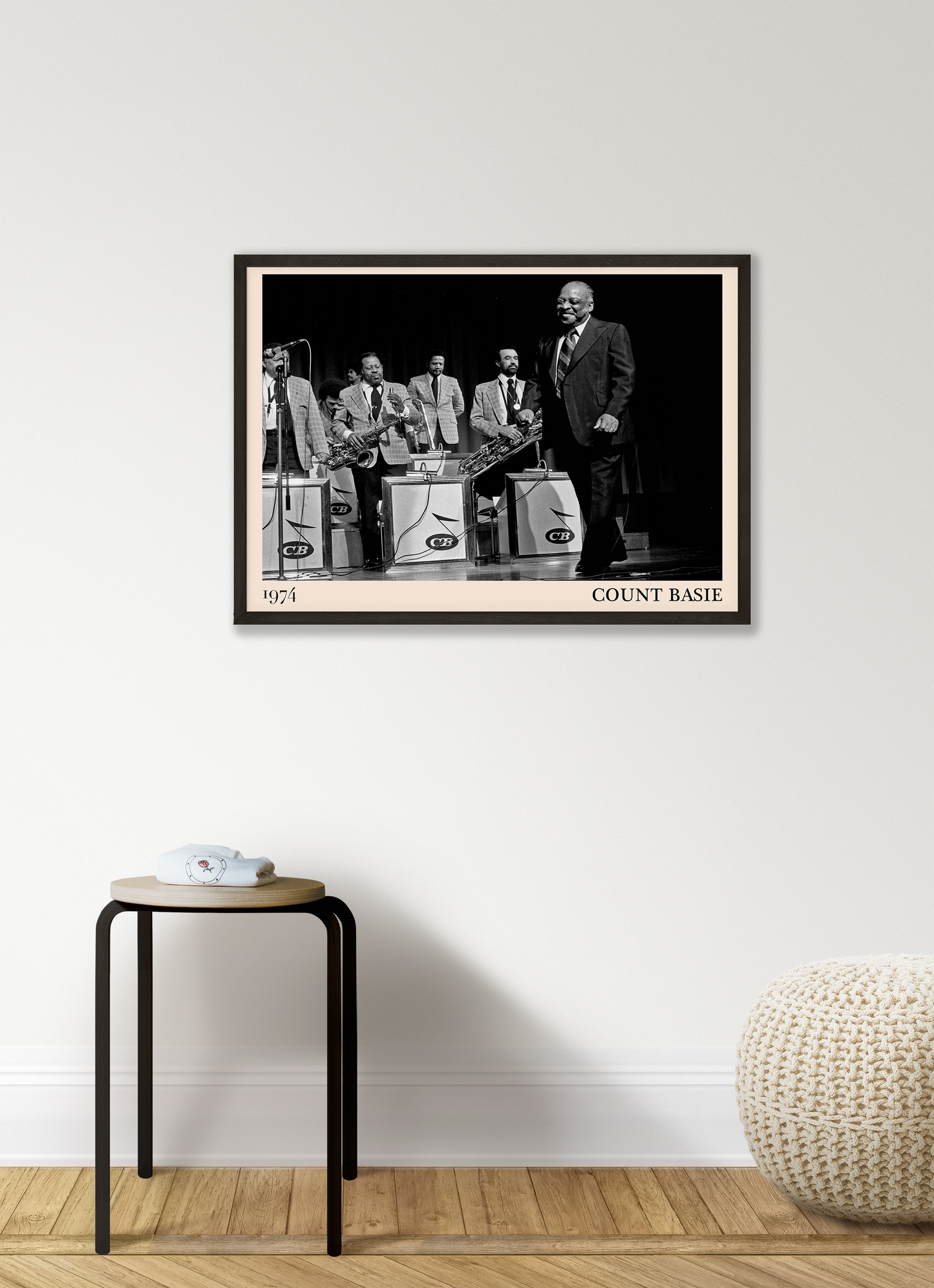 1974 photo of Count Basie crafted into a black framed-poster, hanging on a white living room wall