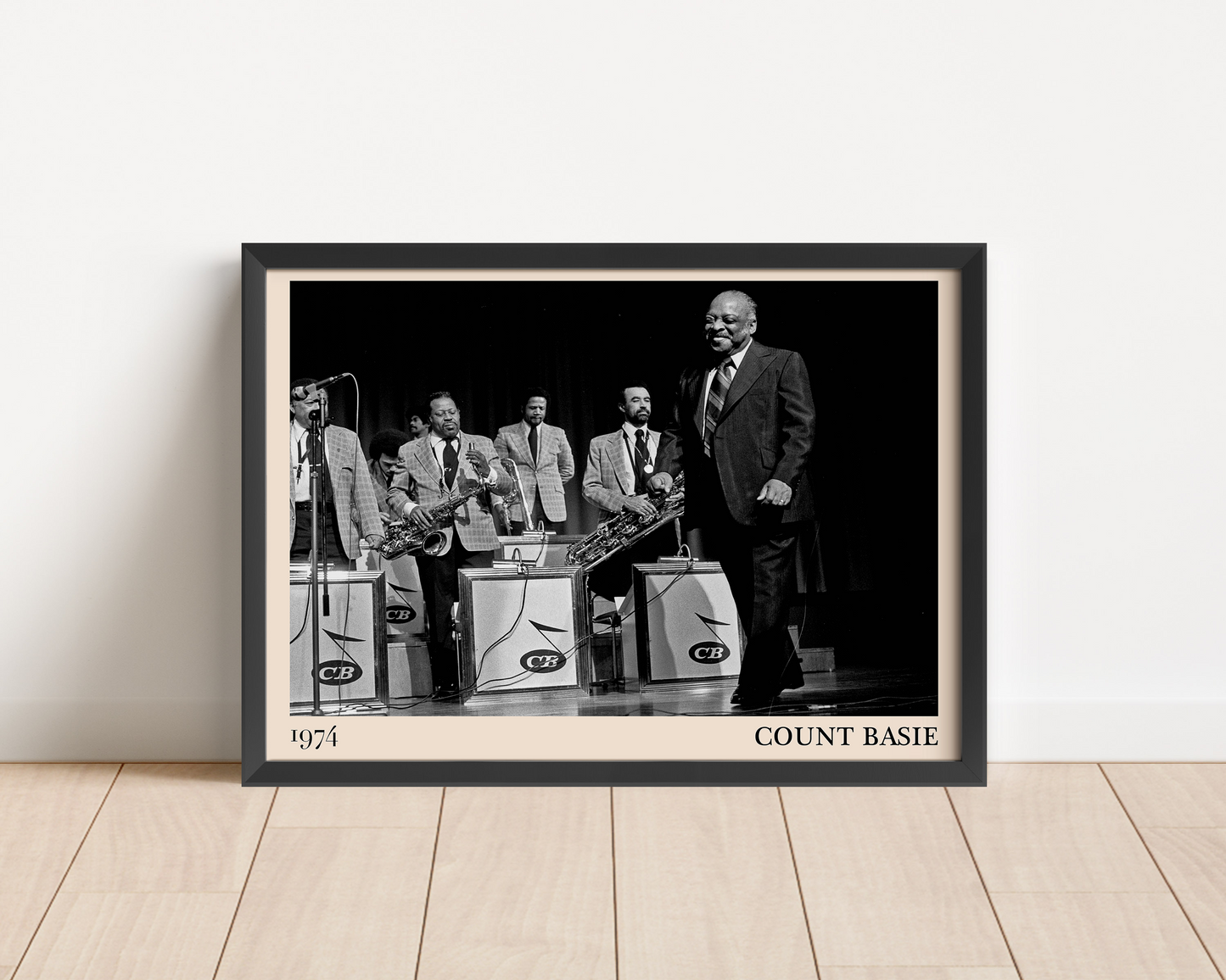 1974 photo of Count Basie crafted into a black framed-poster, leaning against a white wall