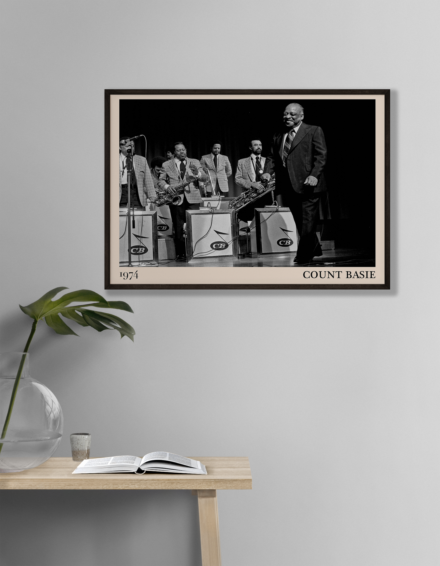 1974 photo of Count Basie crafted into a black framed-poster, hanging on a white living room wall