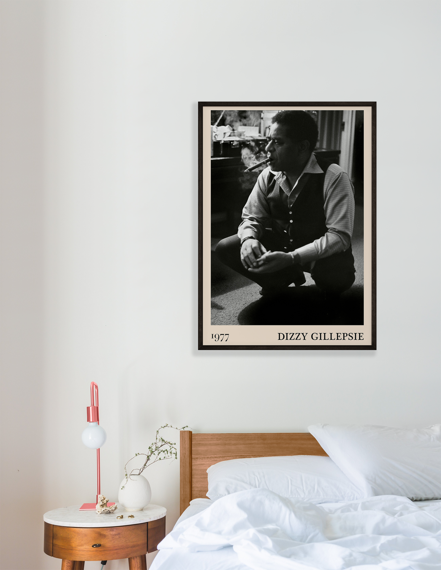 Vintage 1977 photo of Dizzy Gillespie crafted into black framed poster, hanging on a white bedroom wall