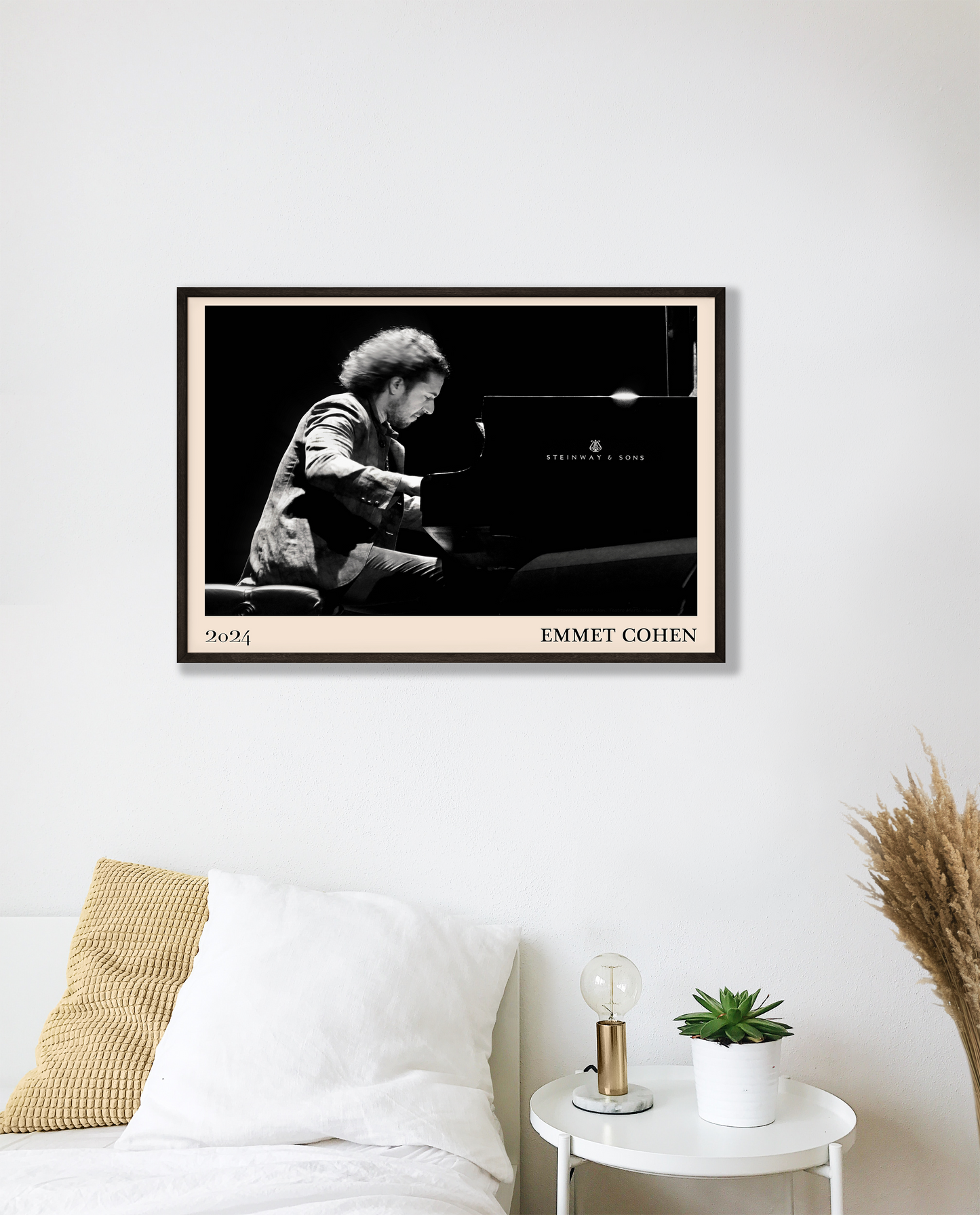 2024 photo of Emmet Cohen crafted into a black framed-poster, hanging on a white bedroom wall