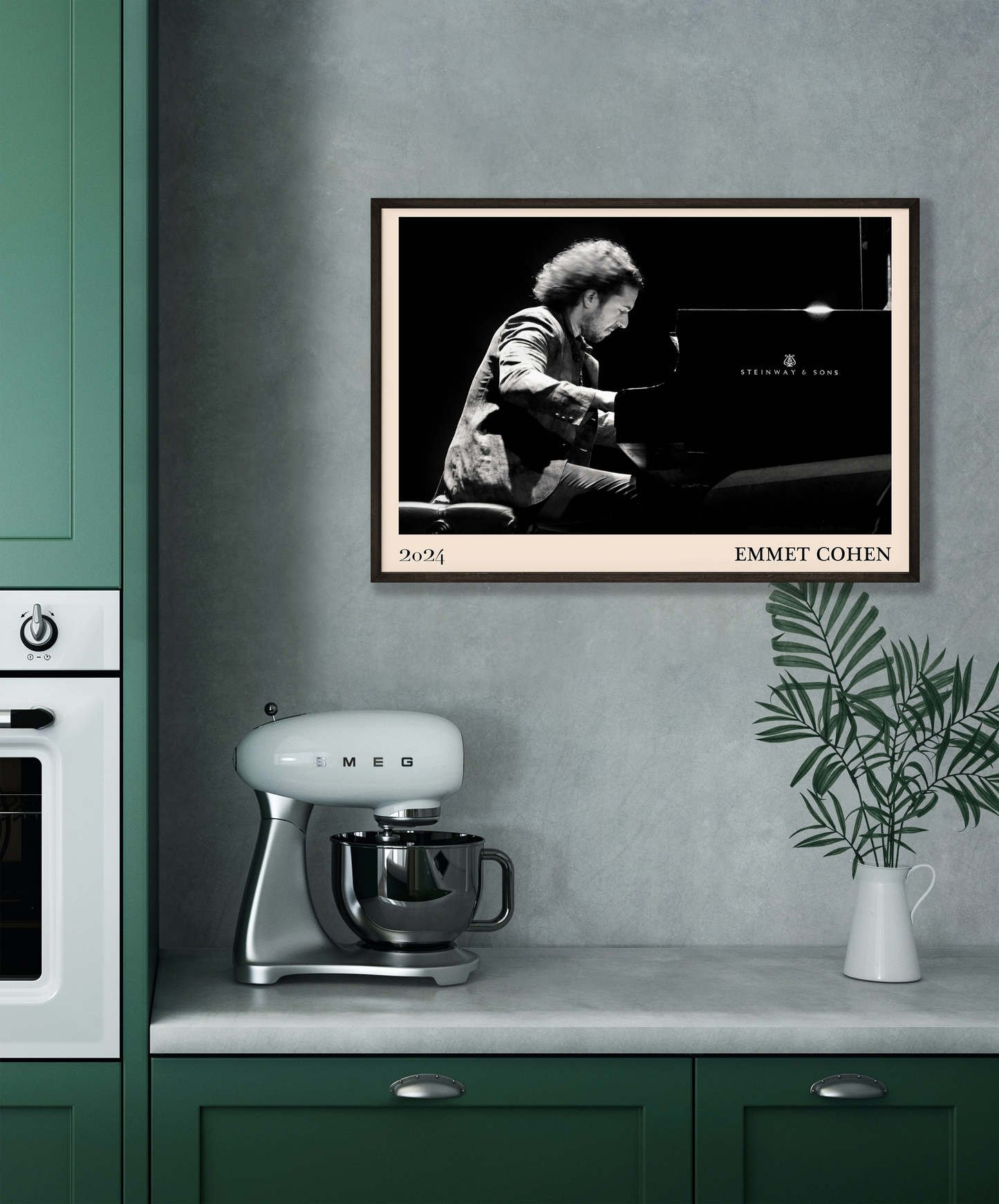 2024 photo of Emmet Cohen crafted into a black framed-poster, hanging on a grey kitchen wall
