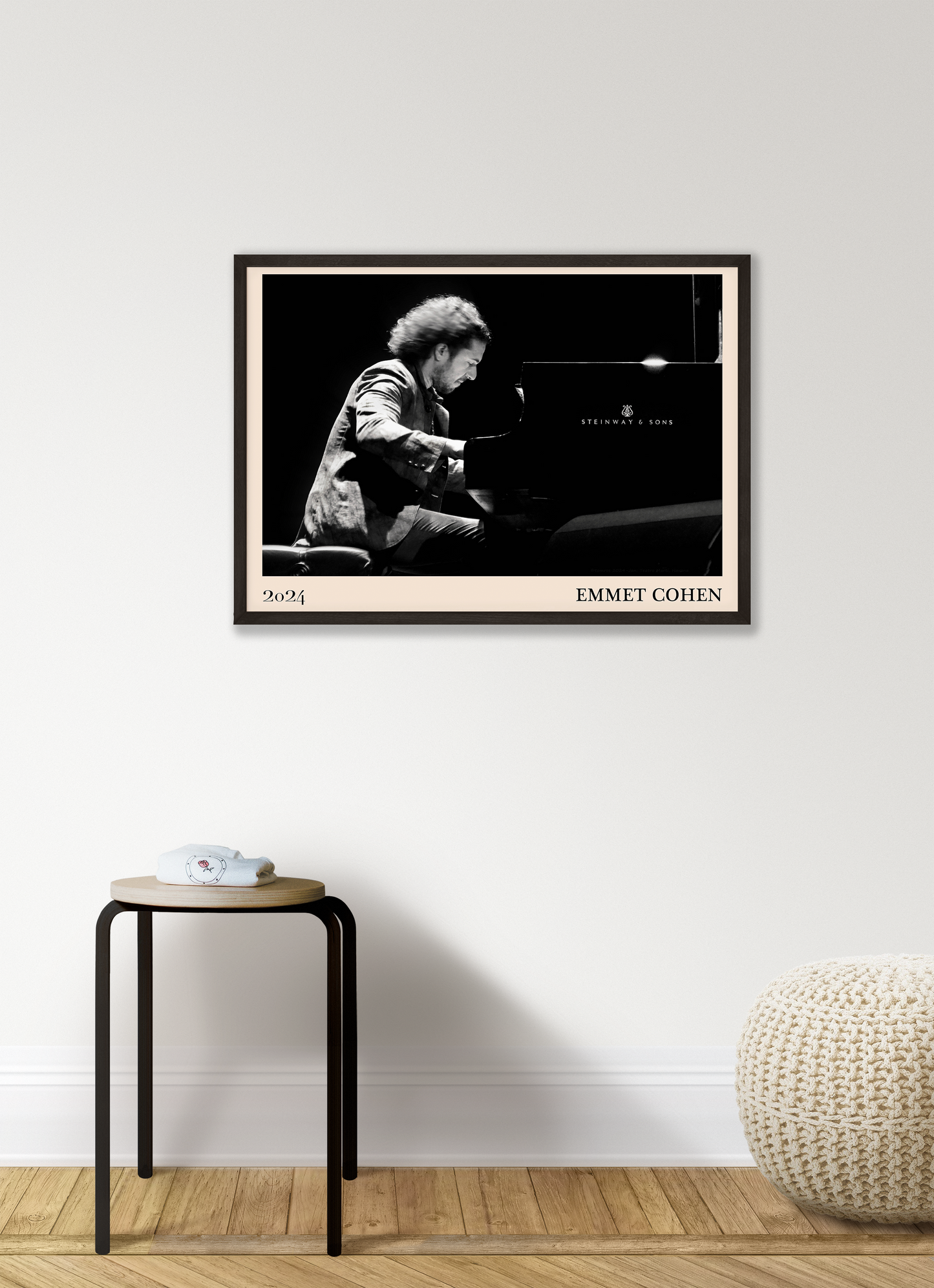 2024 photo of Emmet Cohen crafted into a black framed-poster, hanging on a white living room wall