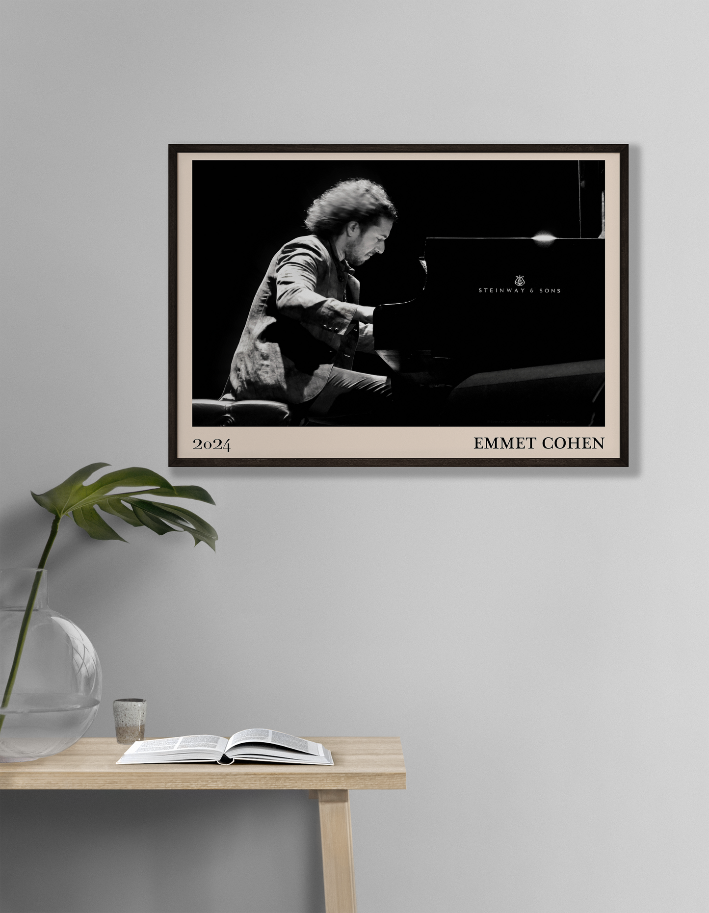 2024 photo of Emmet Cohen crafted into a black framed-poster, hanging on a white living room wall