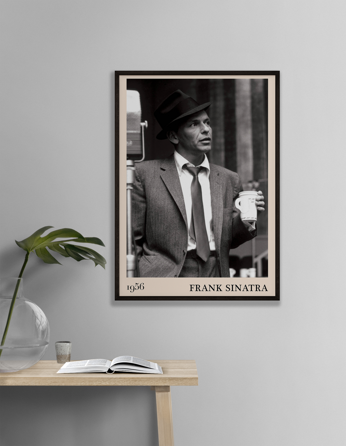 1956 photo of Frank Sinatra crafted into a black framed-poster, hanging on a white living room wall