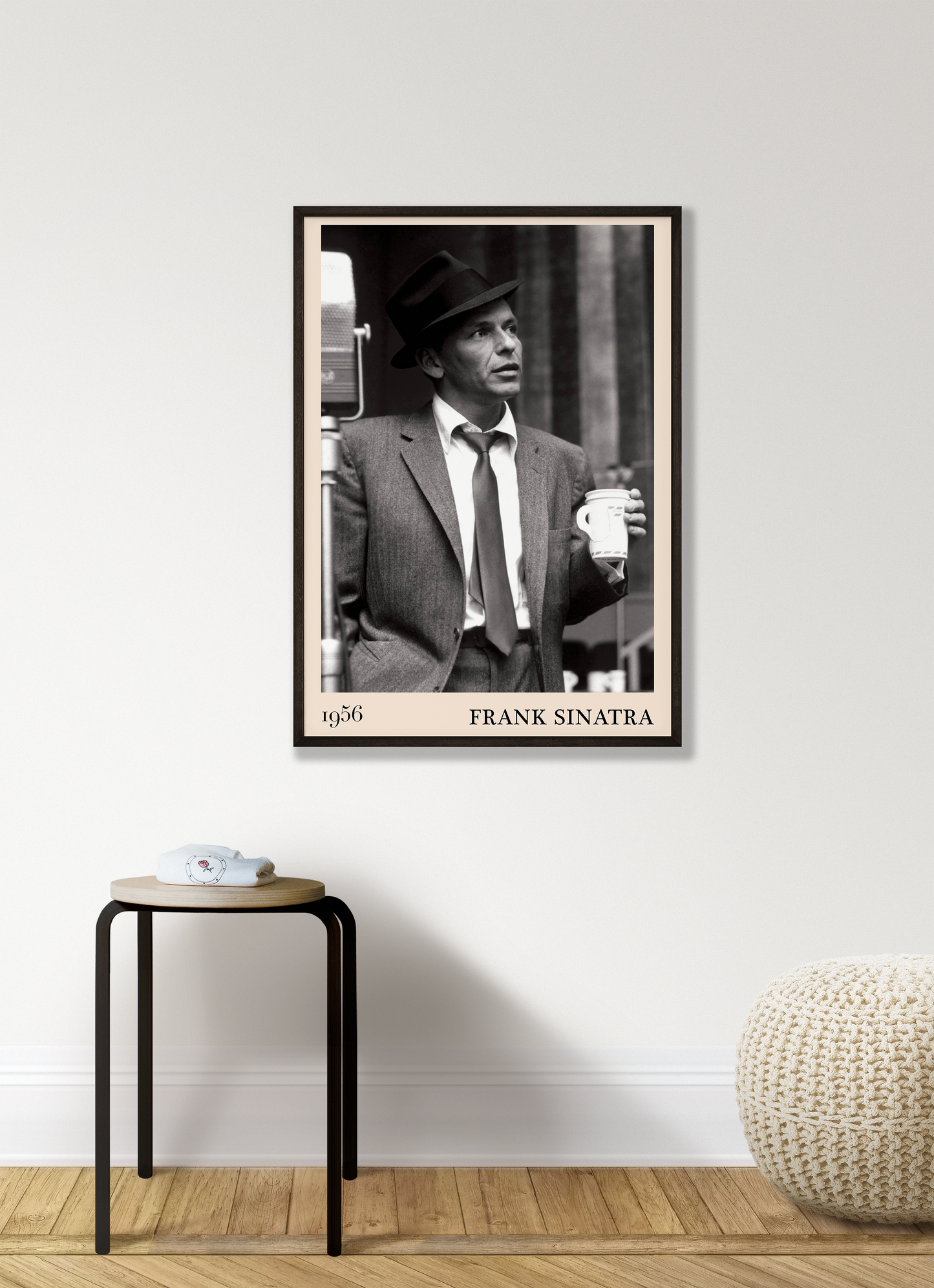 1956 photo of Frank Sinatra crafted into a black framed-poster, hanging on a white living room wall