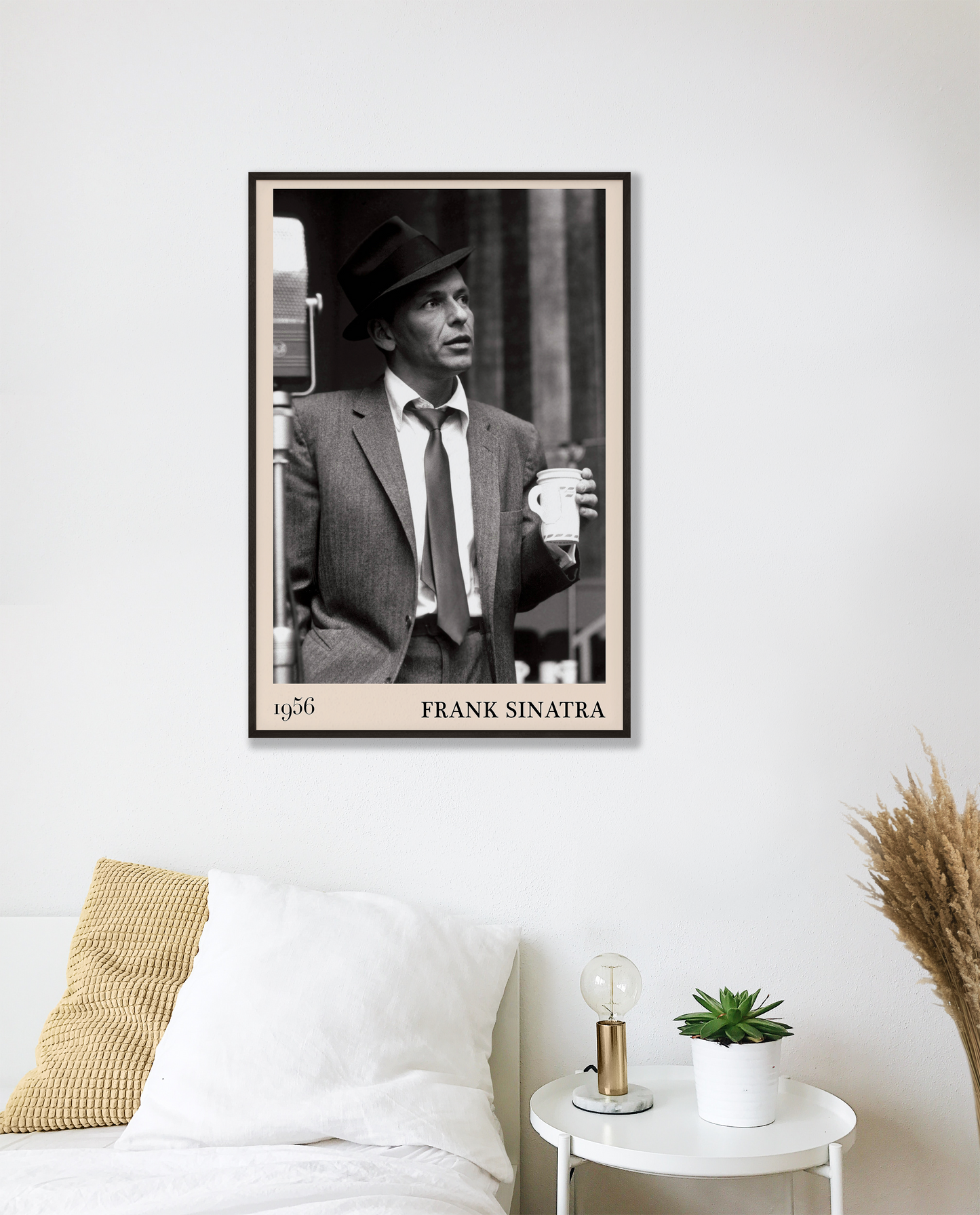 1956 photo of Frank Sinatra crafted into a black framed-poster, hanging on a white bedroom wall