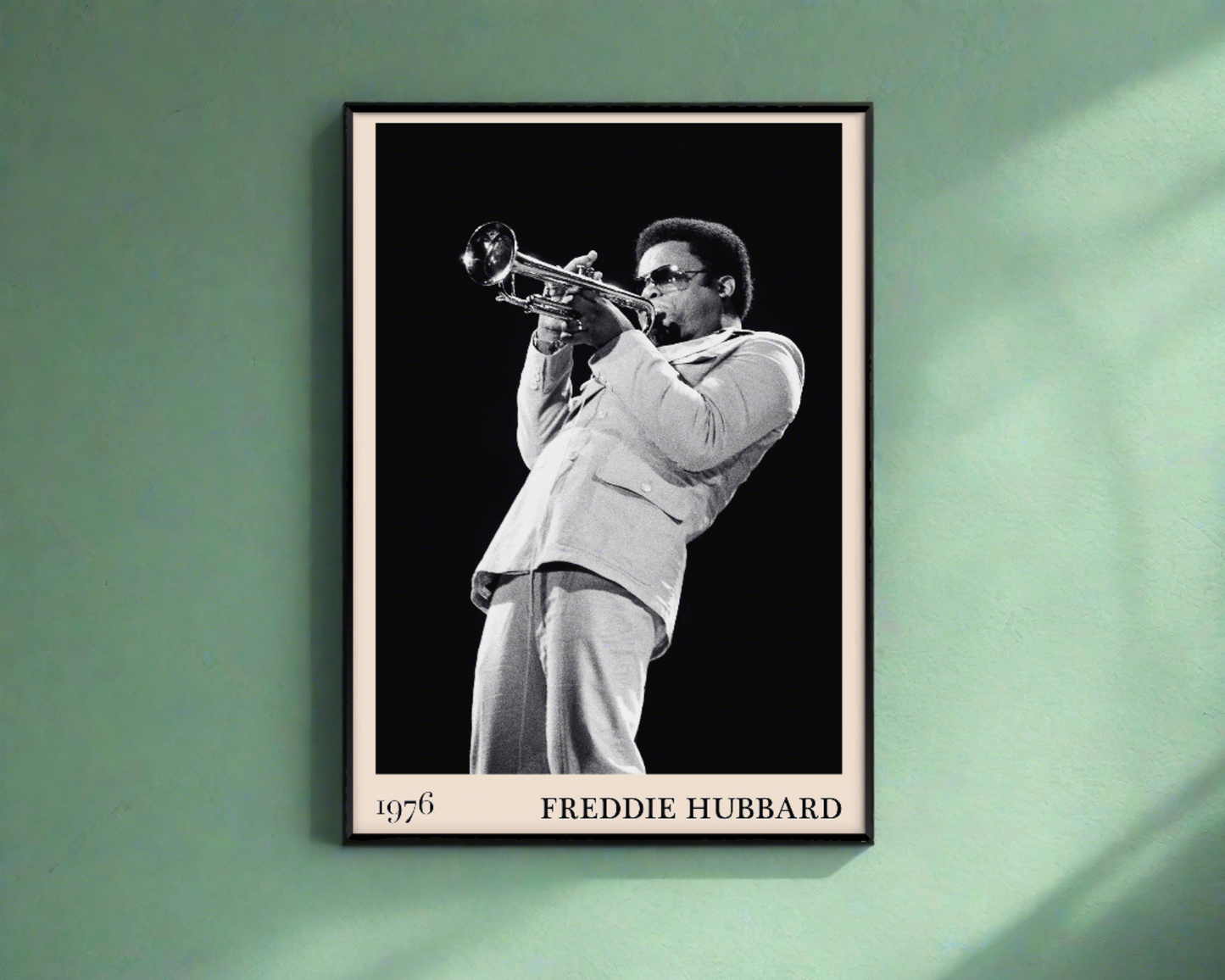 1976 photograph of Freddie Hubbard taken by Thomas Marcello. Picture crafted into a black framed poster, with an off-white border. Poster is hanging on a green wall