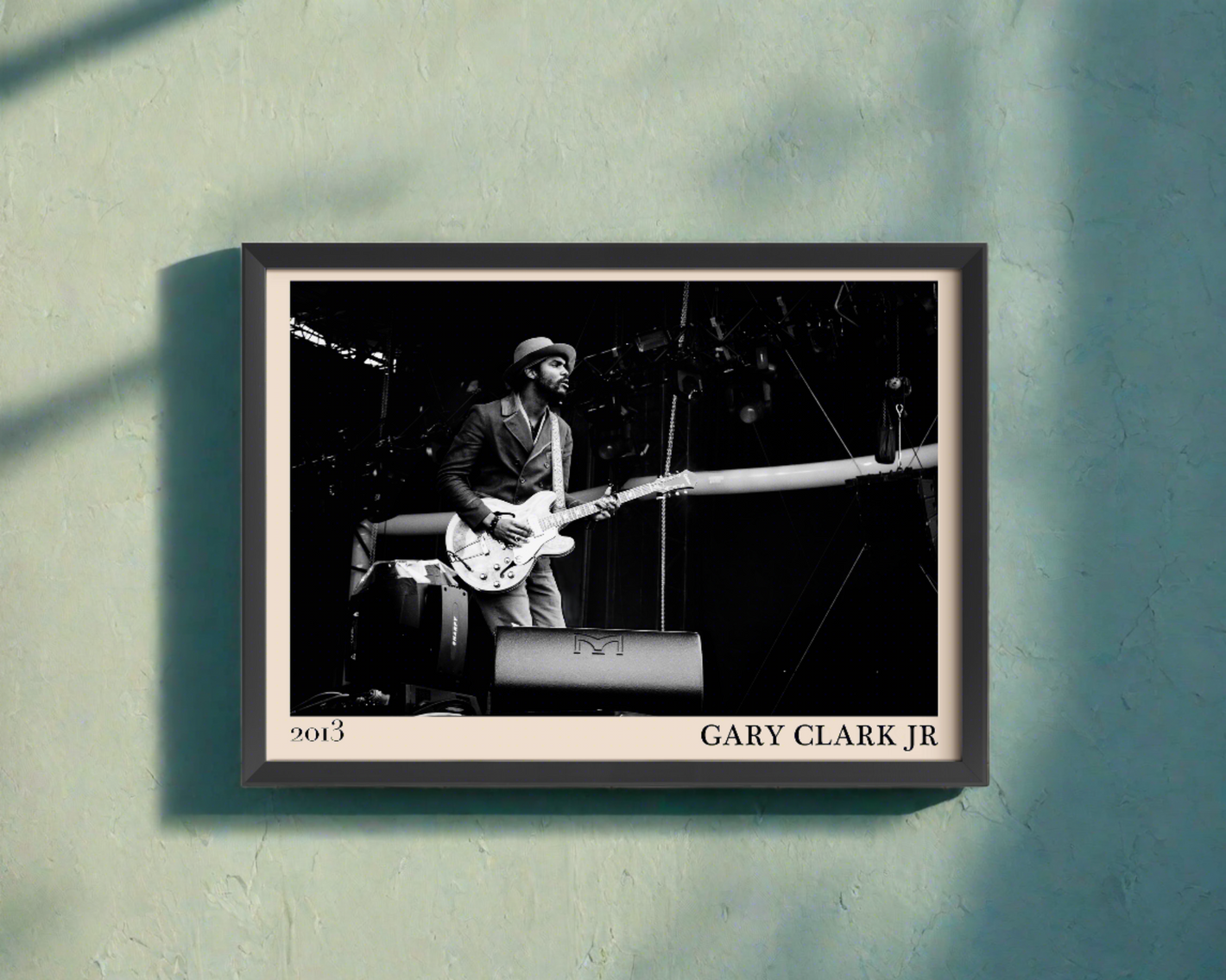 2013 photo of Gary Clark Jr crafted into an elegant black-framed print. Hanging on a blue wall