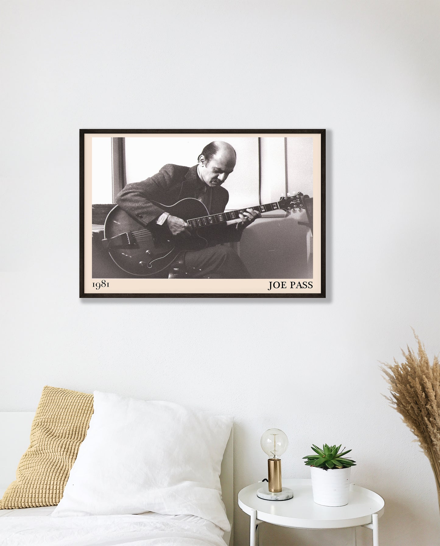 1981 photo of Joe Pass crafted into an elegant black-framed print. Hanging on a white bedroom wall
