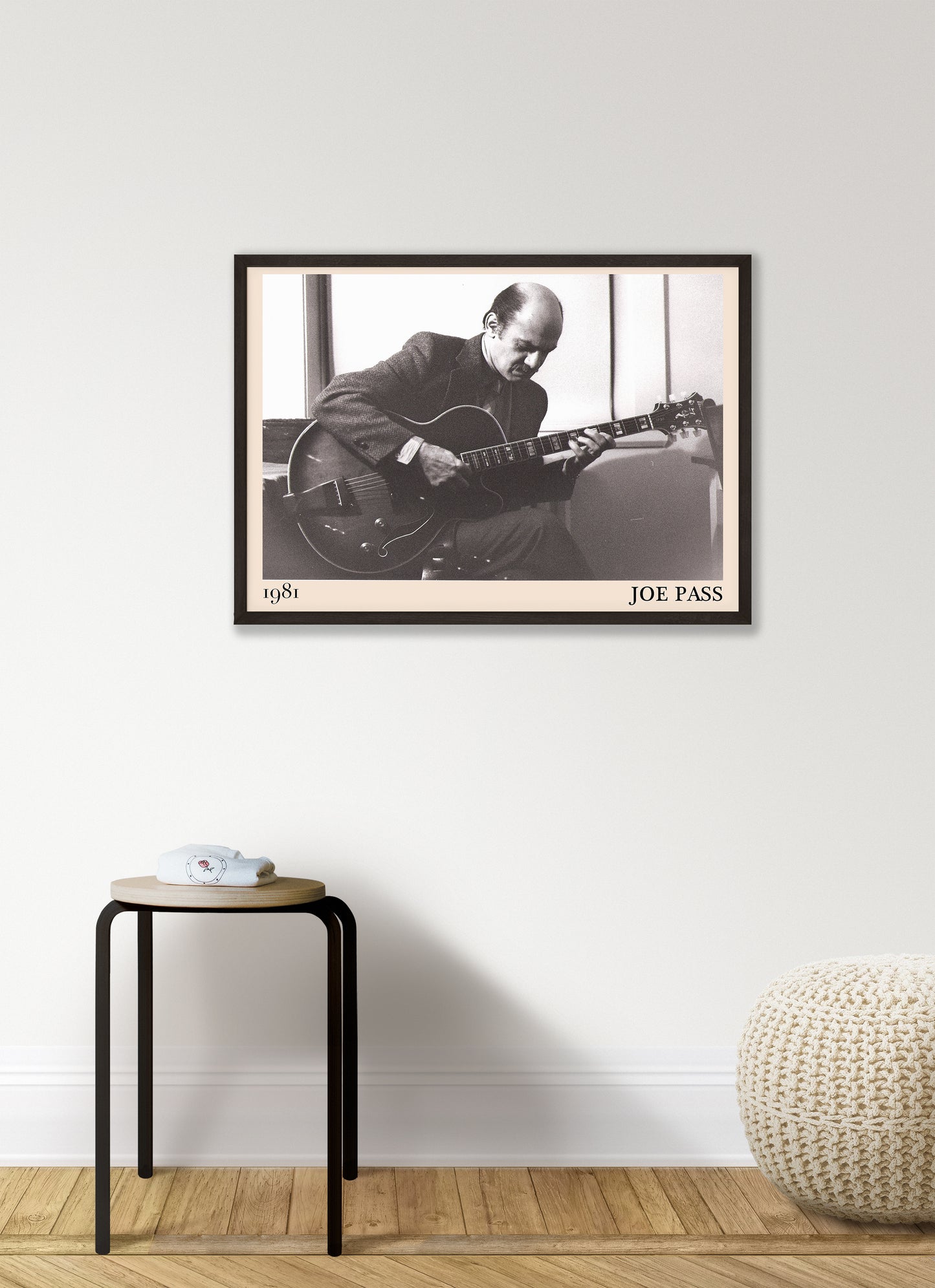 1981 photo of Joe Pass crafted into an elegant black-framed print. Hanging on a white living room wall