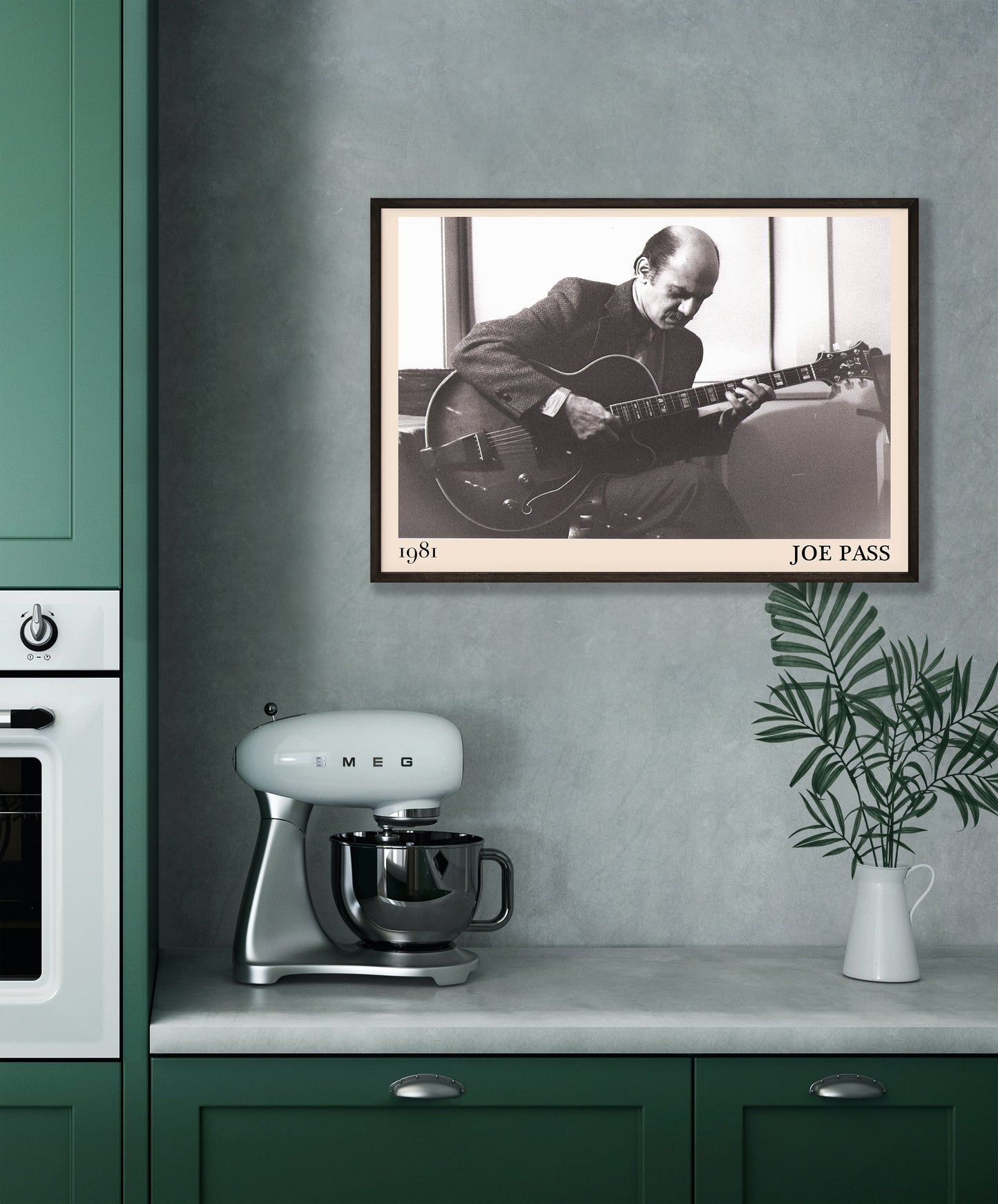 1981 photo of Joe Pass crafted into an elegant black-framed print. Hanging on a grey kitchen wall