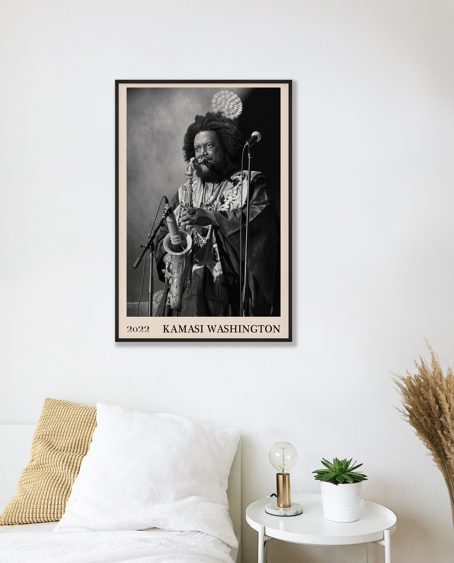 2022 photo of Kamasi Washington crafted into a black framed-poster, hanging on a white bedroom wall