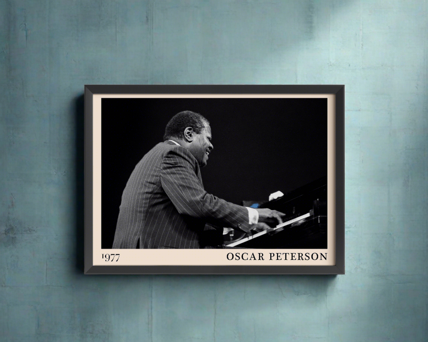 1977 photograph of Oscar Peterson taken by Thomas Marcello. Picture crafted into a black framed poster, with an off-white border. Poster is hanging on a blue wall