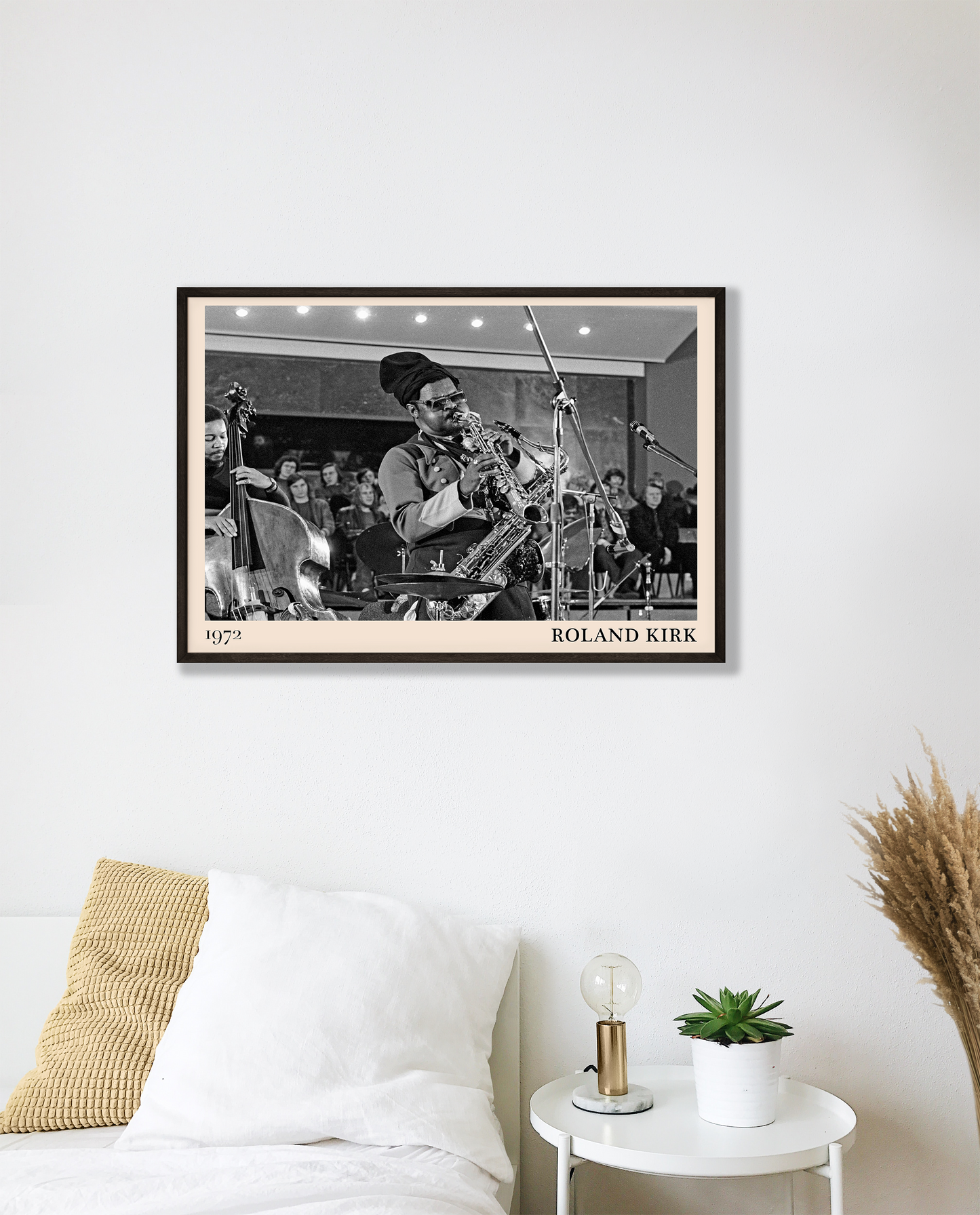 1972 photo of Roland Kirk crafted into a black framed-poster, hanging on a white bedroom wall