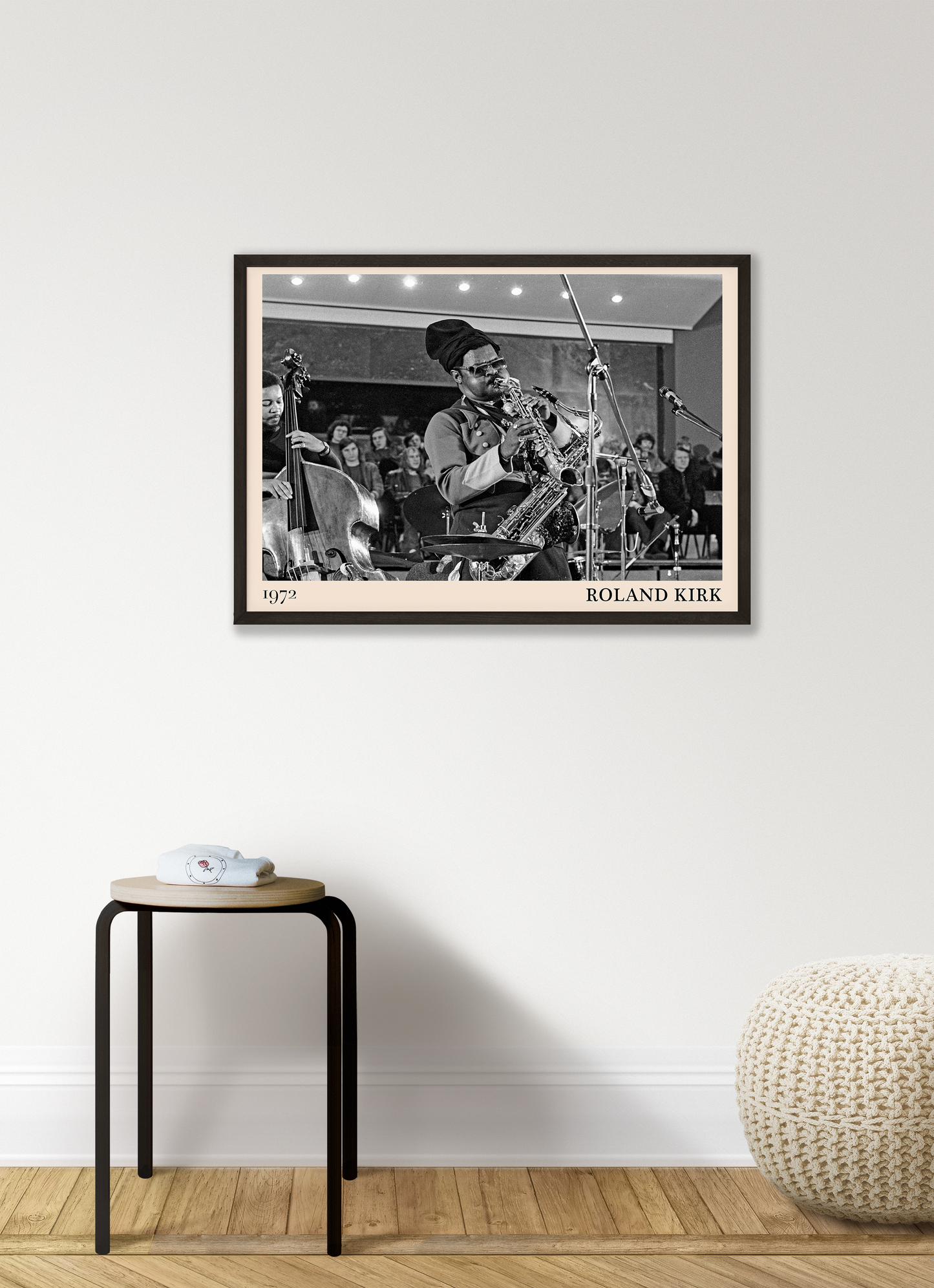 1972 photo of Roland Kirk crafted into a black framed-poster, hanging on a white living room wall