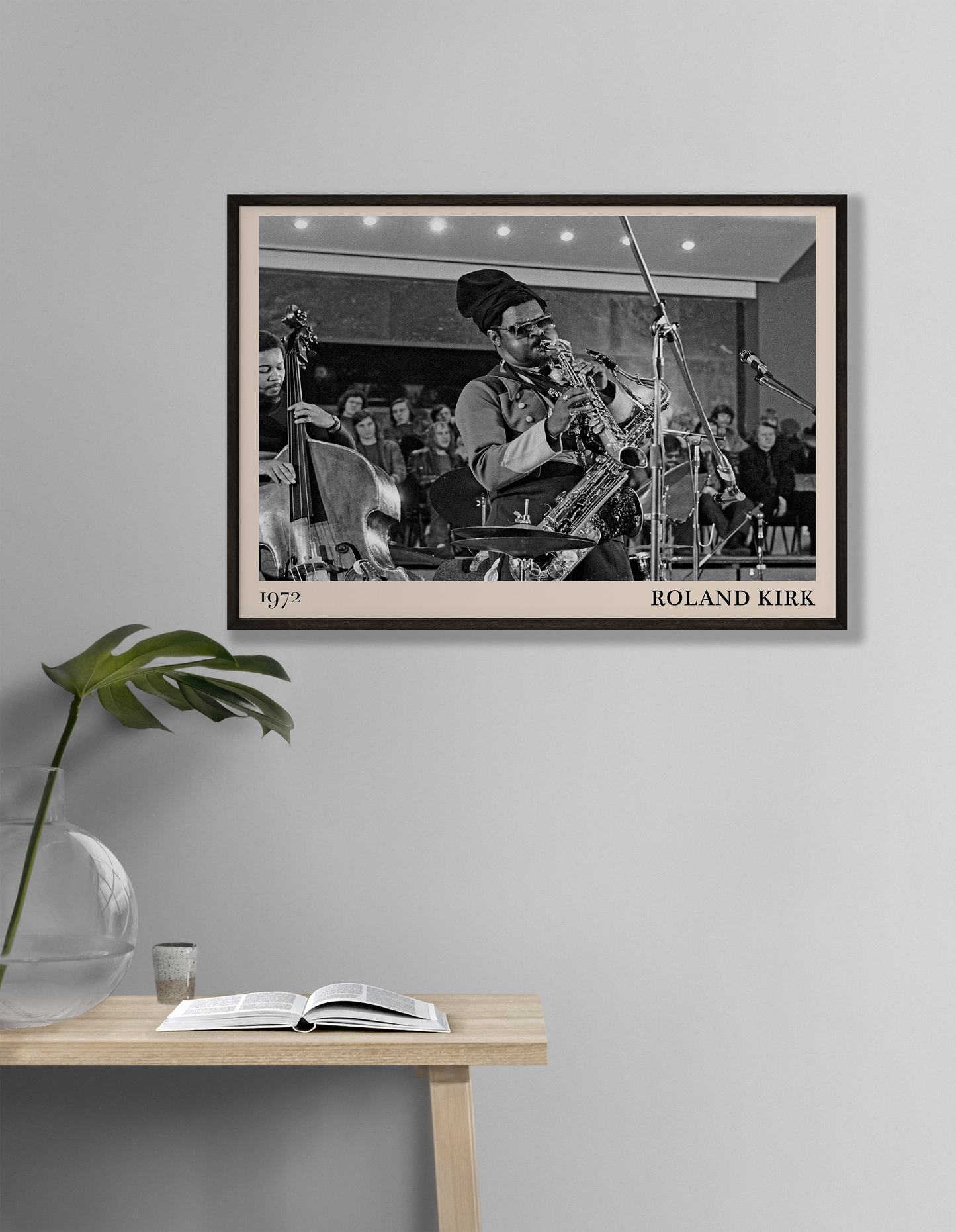 1972 photo of Roland Kirk crafted into a black framed-poster, hanging on a white living room wall