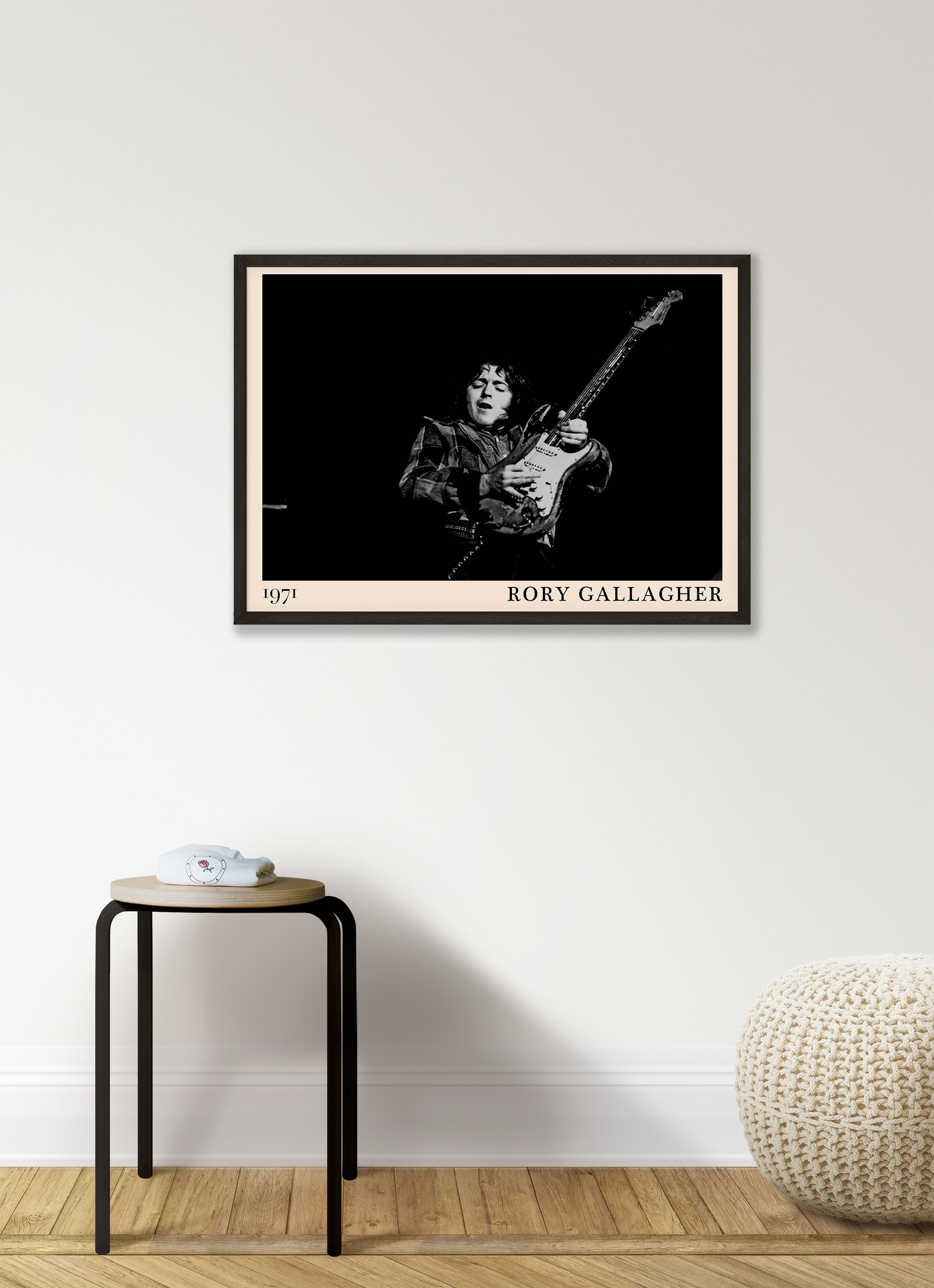 Iconic image of rock musician Rory Gallagher performing, captured by Heinrich Klaffs in 1971 and transformed into vintage-inspired wall decor hanging on a white living room wall