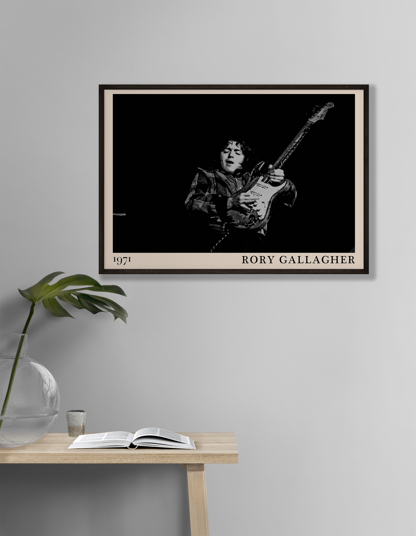 Iconic image of rock musician Rory Gallagher performing, captured by Heinrich Klaffs in 1971 and transformed into vintage-inspired wall decor hanging on a white living room wall