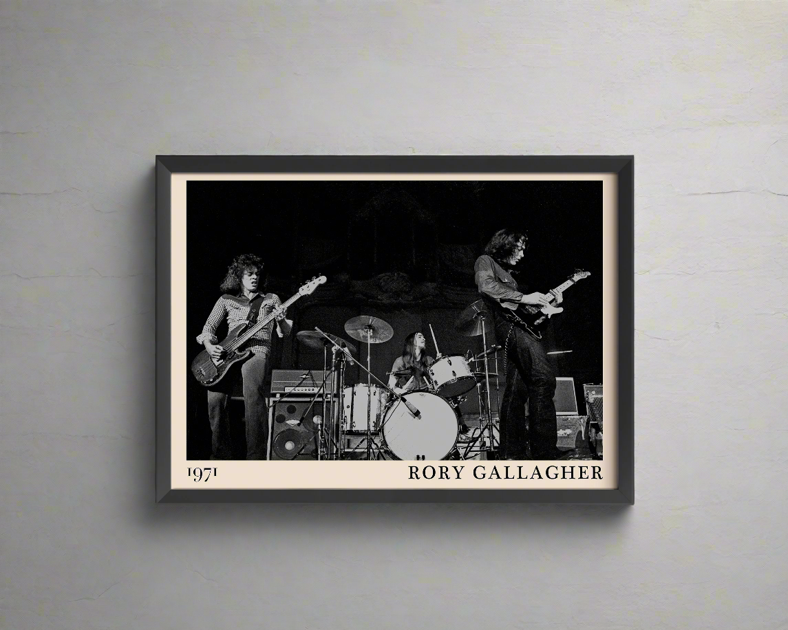 Iconic image of rock band Rory Gallagher performing, captured by Heinrich Klaffs and transformed into vintage-inspired wall decor, hanging on a white rustic concrete wall