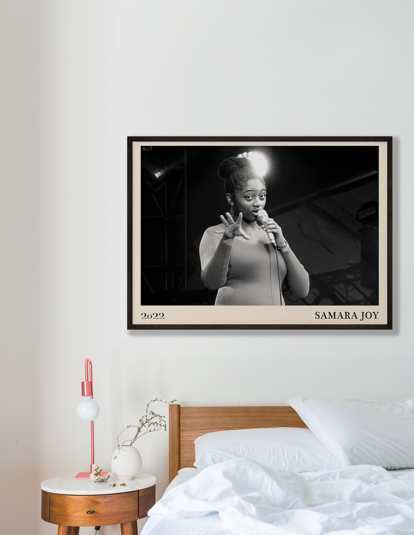 2022 photo of Samara Joy crafted into a black framed-poster, hanging on a white bedroom wall