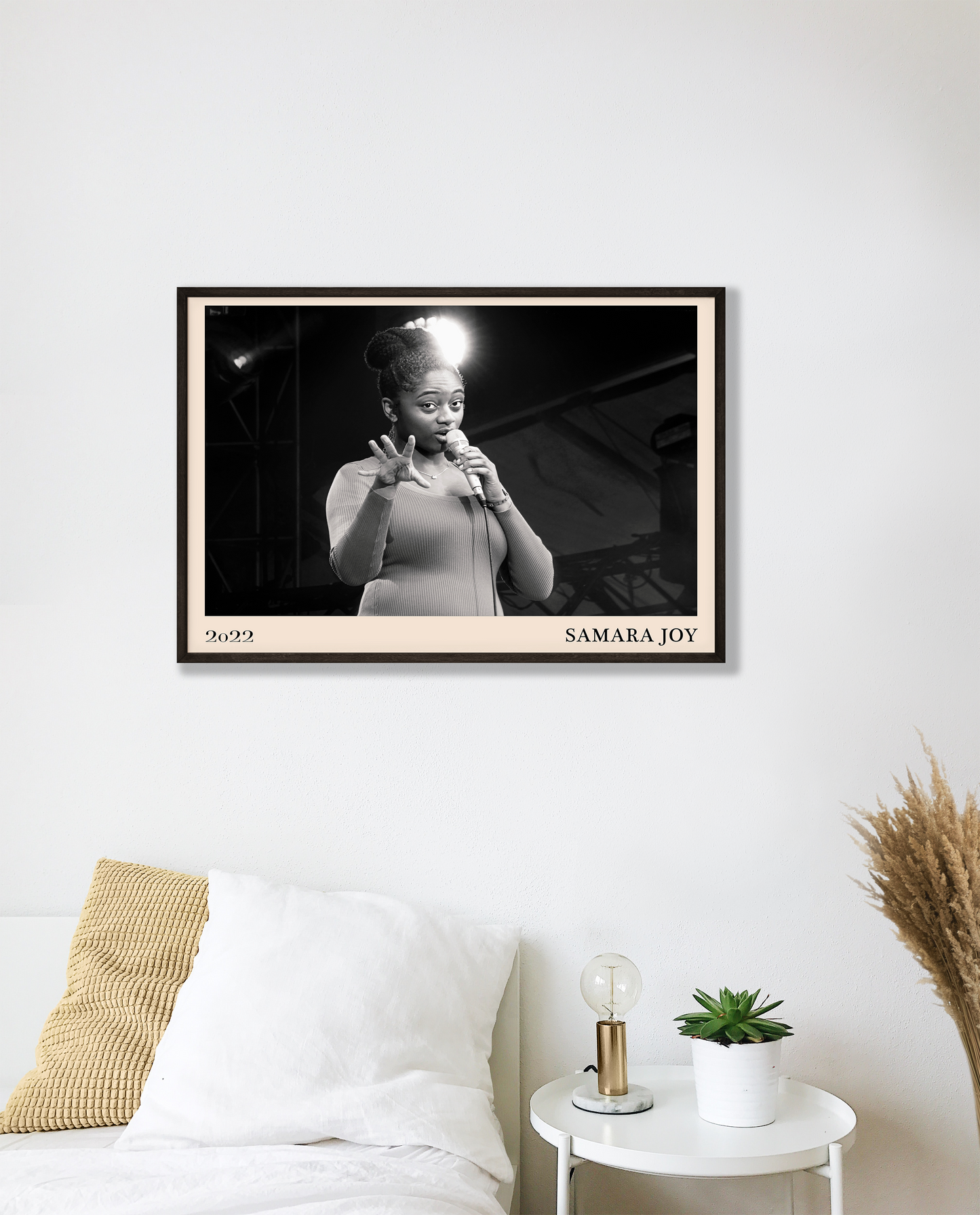 2022 photo of Samara Joy crafted into a black framed-poster, hanging on a white bedroom wall