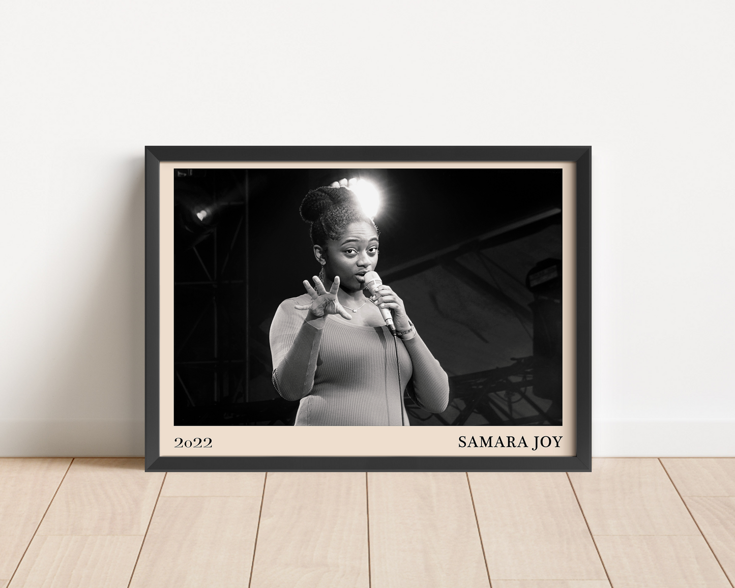 2022 photo of Samara Joy crafted into a black framed-poster, leaning against a white wall
