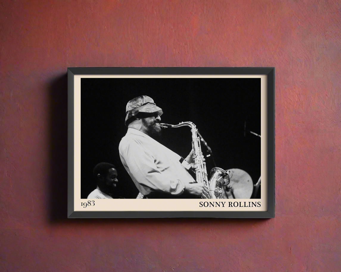 1989 photograph of Sonny Rollins playing the saxophone, transformed into a stylish black-framed jazz poster hanging on a dark red wall