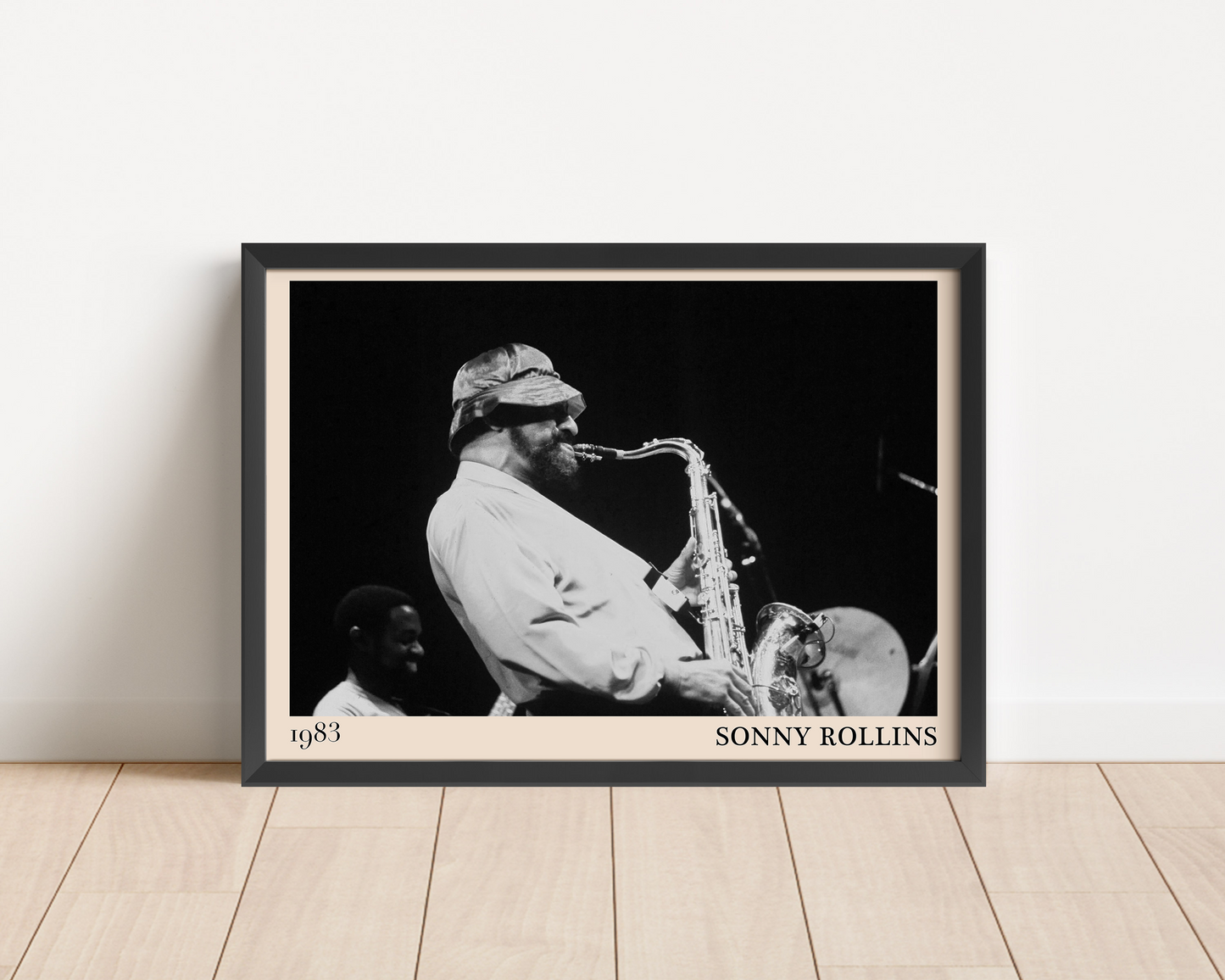 1989 photograph of Sonny Rollins playing the saxophone, transformed into a stylish black-framed jazz poster leaning on a white wall