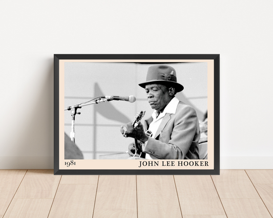John Lee Hooker Blues Poster in landscape mockup, framed on wooden floor, features black and white vintage musician photo.