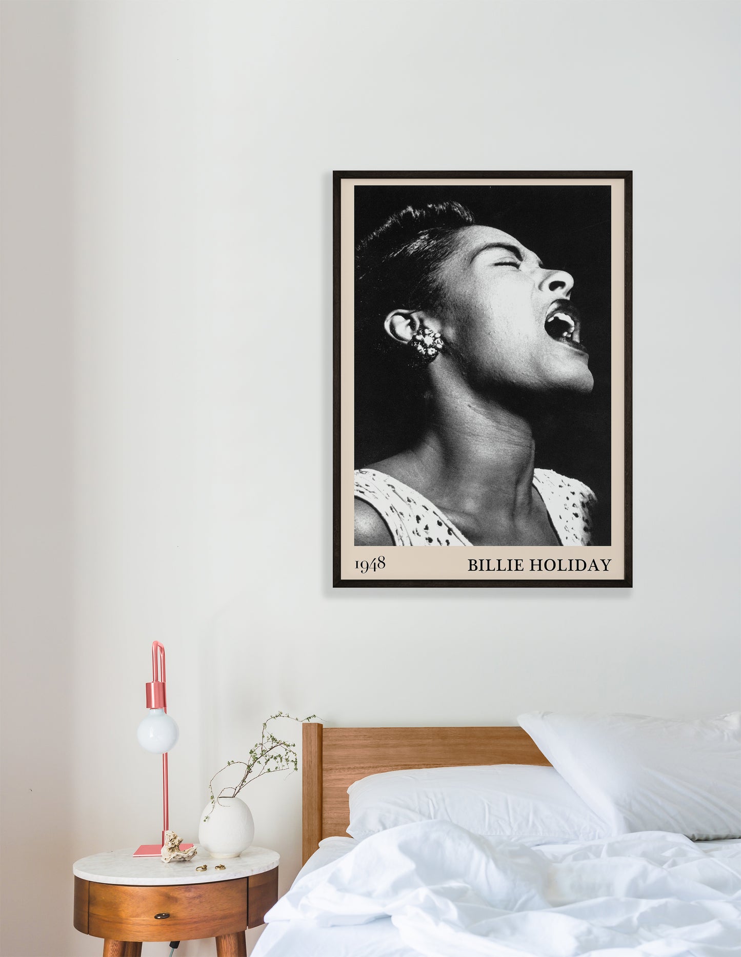 1948 photo of Billie Holiday crafted into an elegant black-framed print, hanging on a white bedroom wall