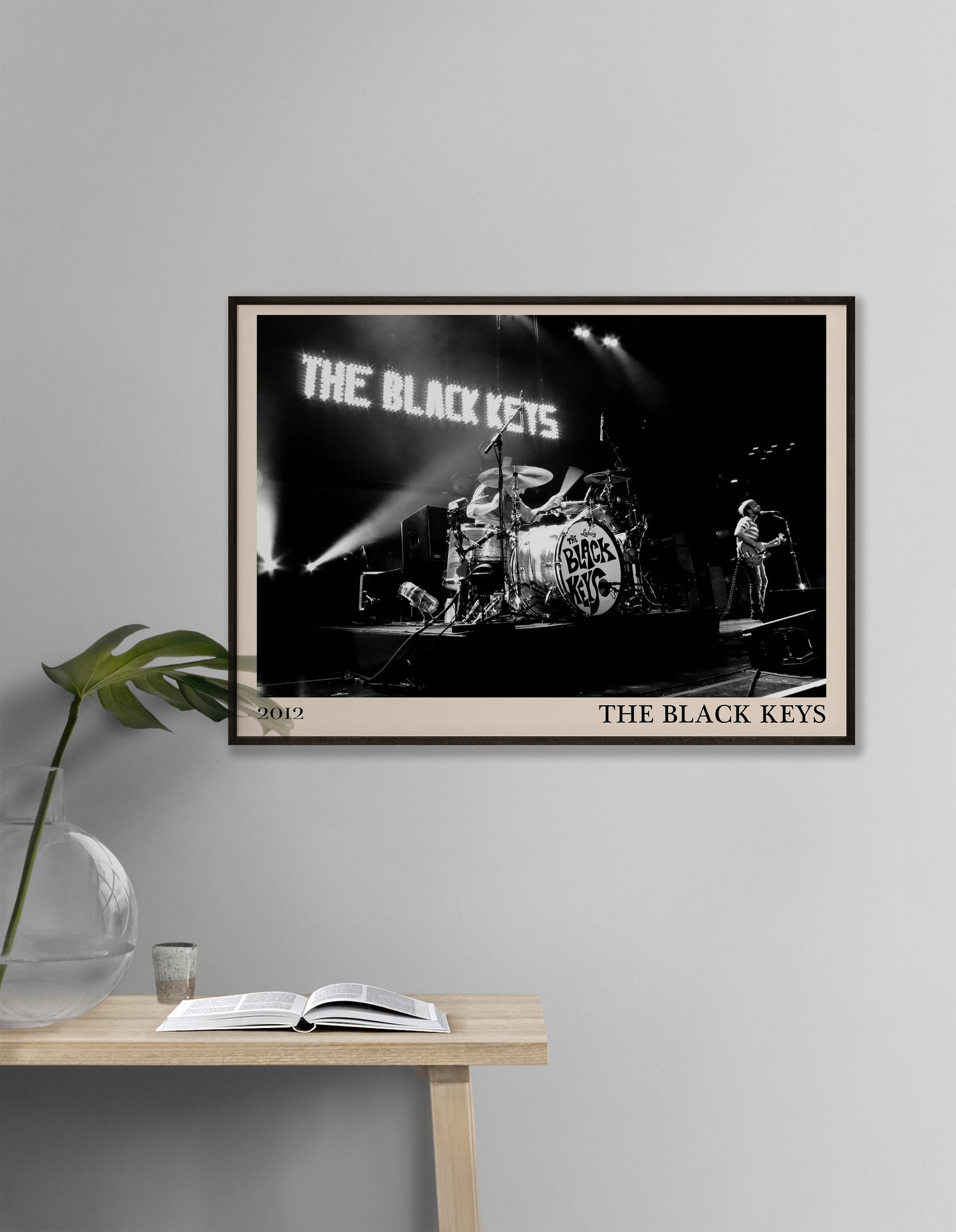 Black Keys photo from 2012 mocked up into a stylish looking vintage print, hanging on a white living room wall