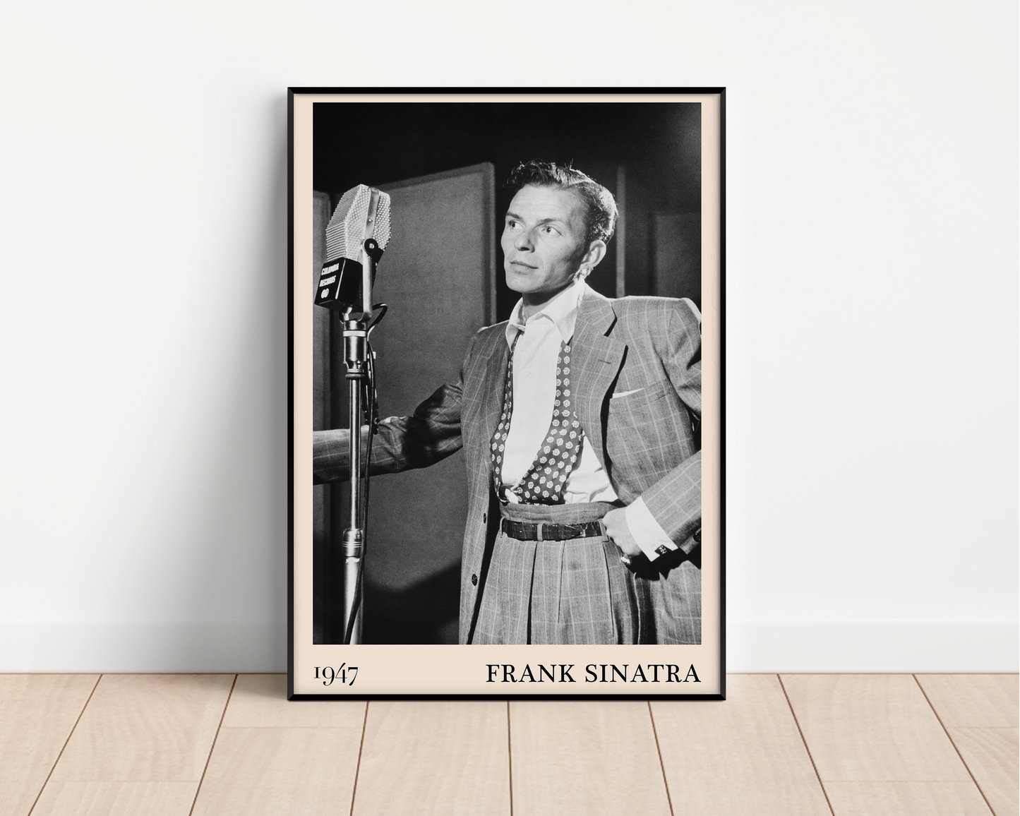 1947 photo of Frank Sinatra crafted into a black framed-poster, leaning against a white wall