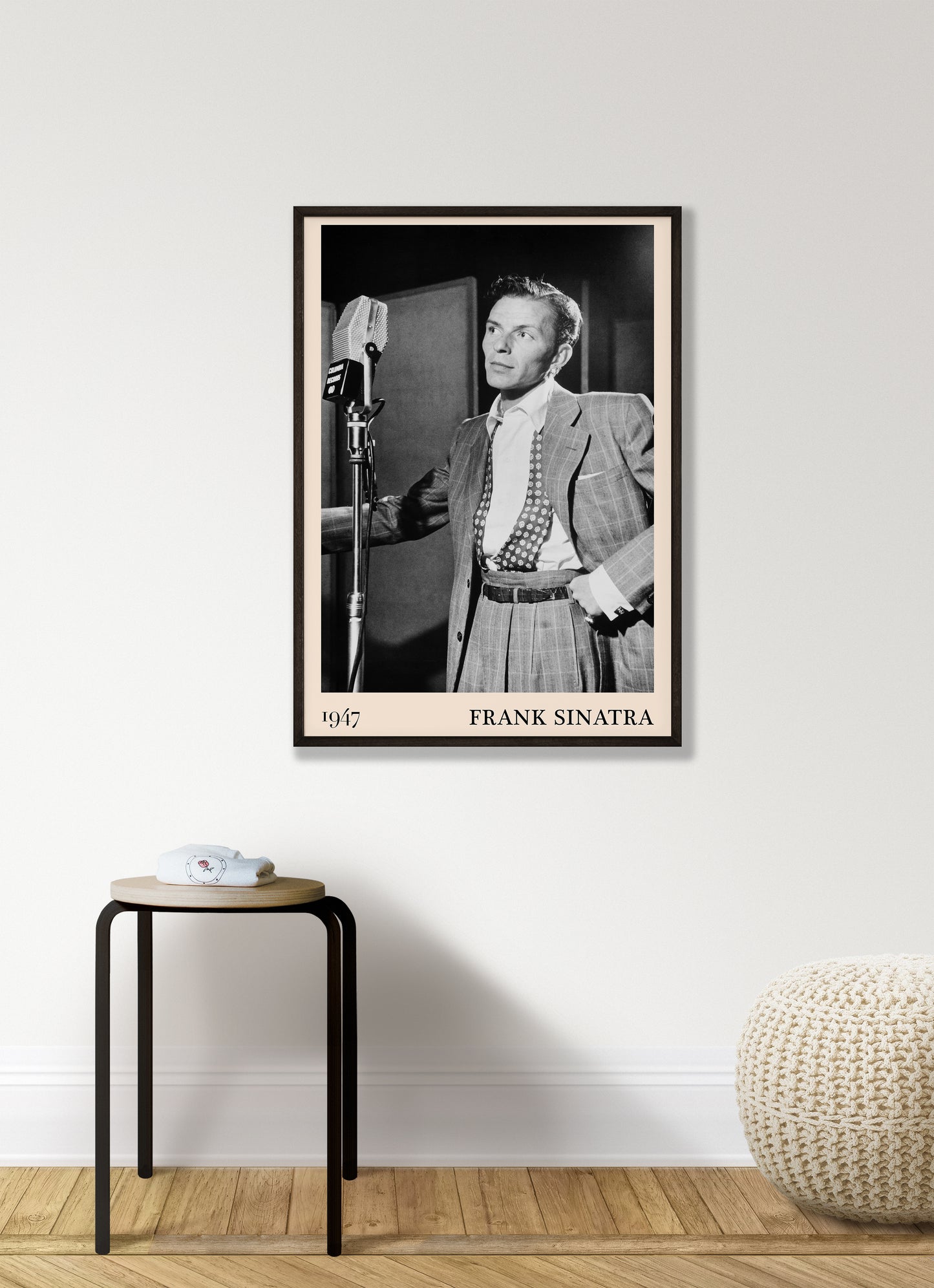 1947 photo of Frank Sinatra crafted into a black framed-poster, hanging on a white living room wall