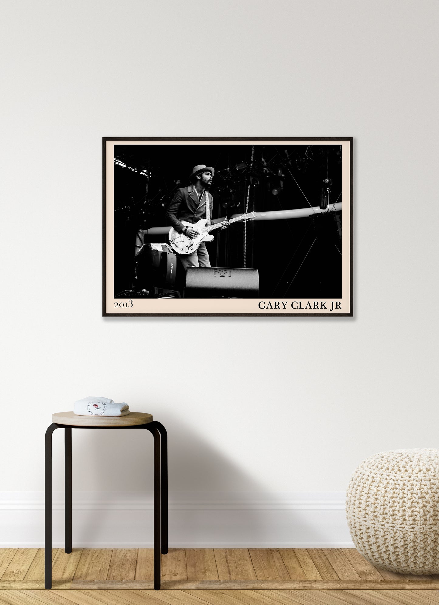 2013 photo of Gary Clark Jr crafted into an elegant black-framed print. Hanging on a white living room wall