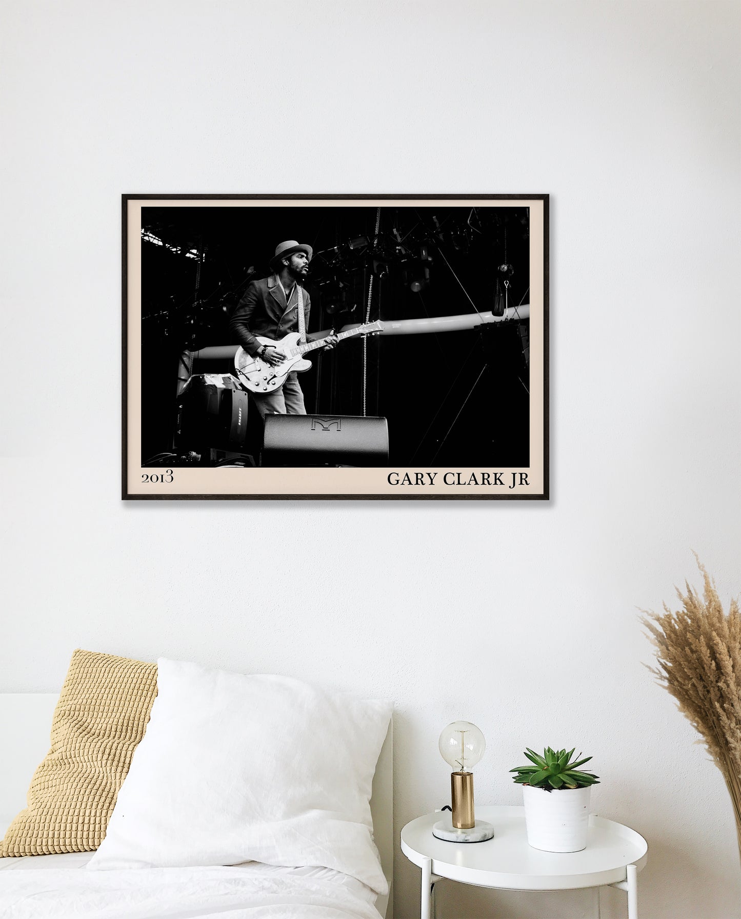 2013 photo of Gary Clark Jr crafted into an elegant black-framed print. Hanging on a white bedroom wall